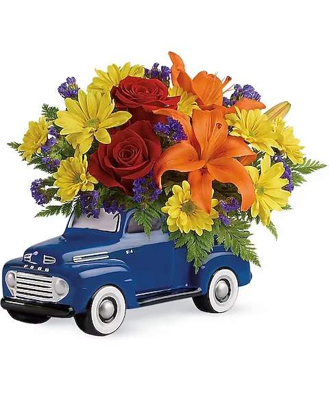 Vintage Ford Pickup Bouquet by Teleflora - Vroom vroom! Get Dad's motor running this Father's Day with a freewheelin' gift he'll never forget - a bold bouquet of roses, lilies and mums, hand-delivered in a '48 Ford Pickup. Hand-painted in classic blue, this ceramic collectible is one-of-a-kind, just like Dad.  This little pickup includes red roses, orange asiatic lilies, yellow daisy spray chrysanthemums, purple sinuata statice, and leatherleaf fern. Delivered in a '48 Ford Pickup collectible keepsake.
