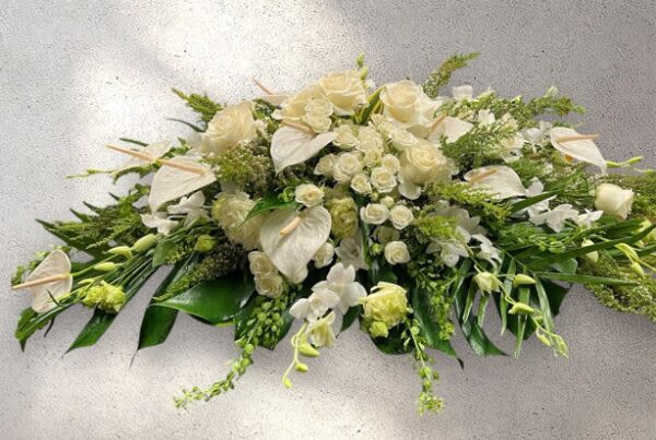 White Casket Spray/ 5-7 Days - Please allow 5–7 business days for all sympathy arrangements to ensure they arrive with care and consideration. Orders without a proper delivery date will be canceled.   Please contact the shop for further details