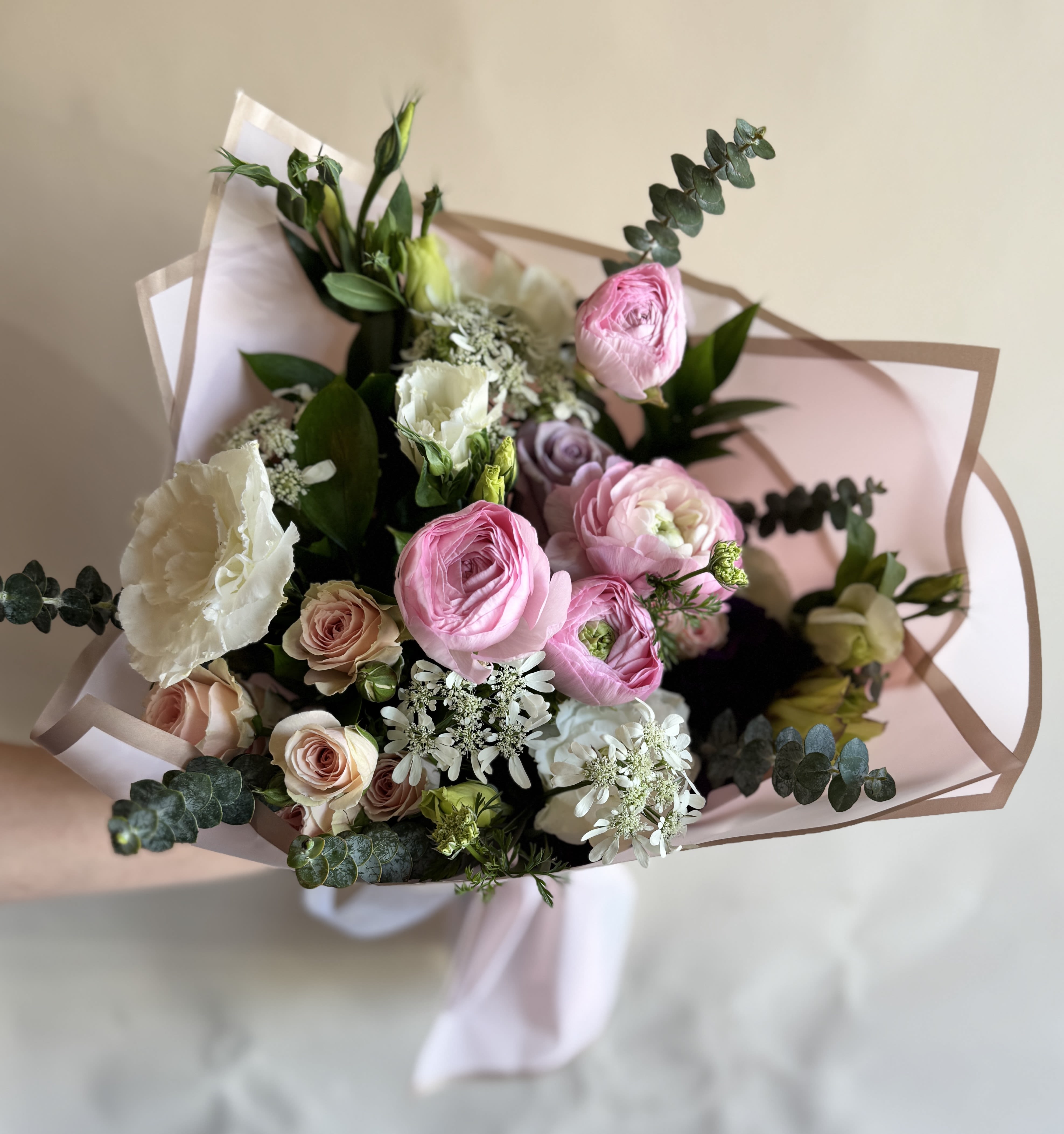 Designer's Choice: Wrapped Bouquet  - Mix of roses, ranunculus, and lisianthus wrapped in paper with a beautiful bow. For that someone special in your life.