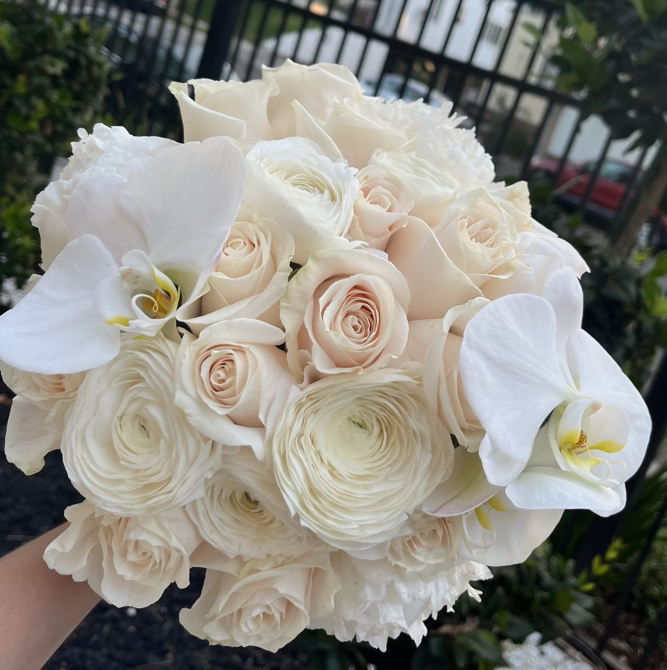 Bridal Whisper Bridal Whisper - A vision of pure elegance, Bridal Whisper is designed for the bride who adores classic beauty with a modern touch. Creamy blush roses, delicate ranunculus, and lush white phalaenopsis orchids form a cloudlike bouquet—soft, graceful, and impossibly romantic. Each petal tells a story of love, promise, and new beginnings. With subtle notes of rosewater and fresh floral powder, this bouquet carries a whisper of fragrance that lingers gently in the air—perfectly complementing the most memorable walk of your life. Style: Timeless, luxurious, bridal couture Scent: Soft rosewater, delicate floral powder