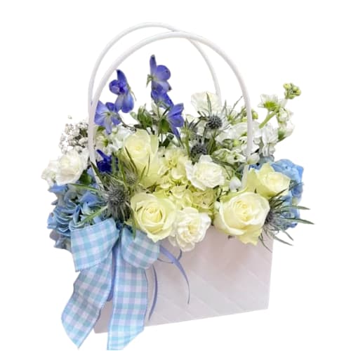 Blue &amp; White Bloom - &quot;Blue &amp; White Bloom&quot; is a modern and minimalist take on the classic floral arrangement. This chic design features a curated selection of blue and white flowers artfully arranged within a stylish purse, offering a touch of understated elegance.