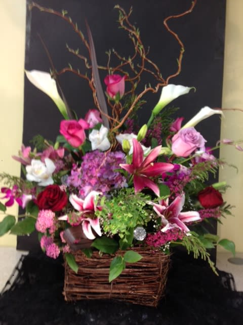 Curly Vine Basket - Beautiful fresh cut callas, roses, hydrangea, stargazers, dendrobium and premium fills adorn this squared off curly vine basket with beautiful curly willow accents, a simply spectacular gift.