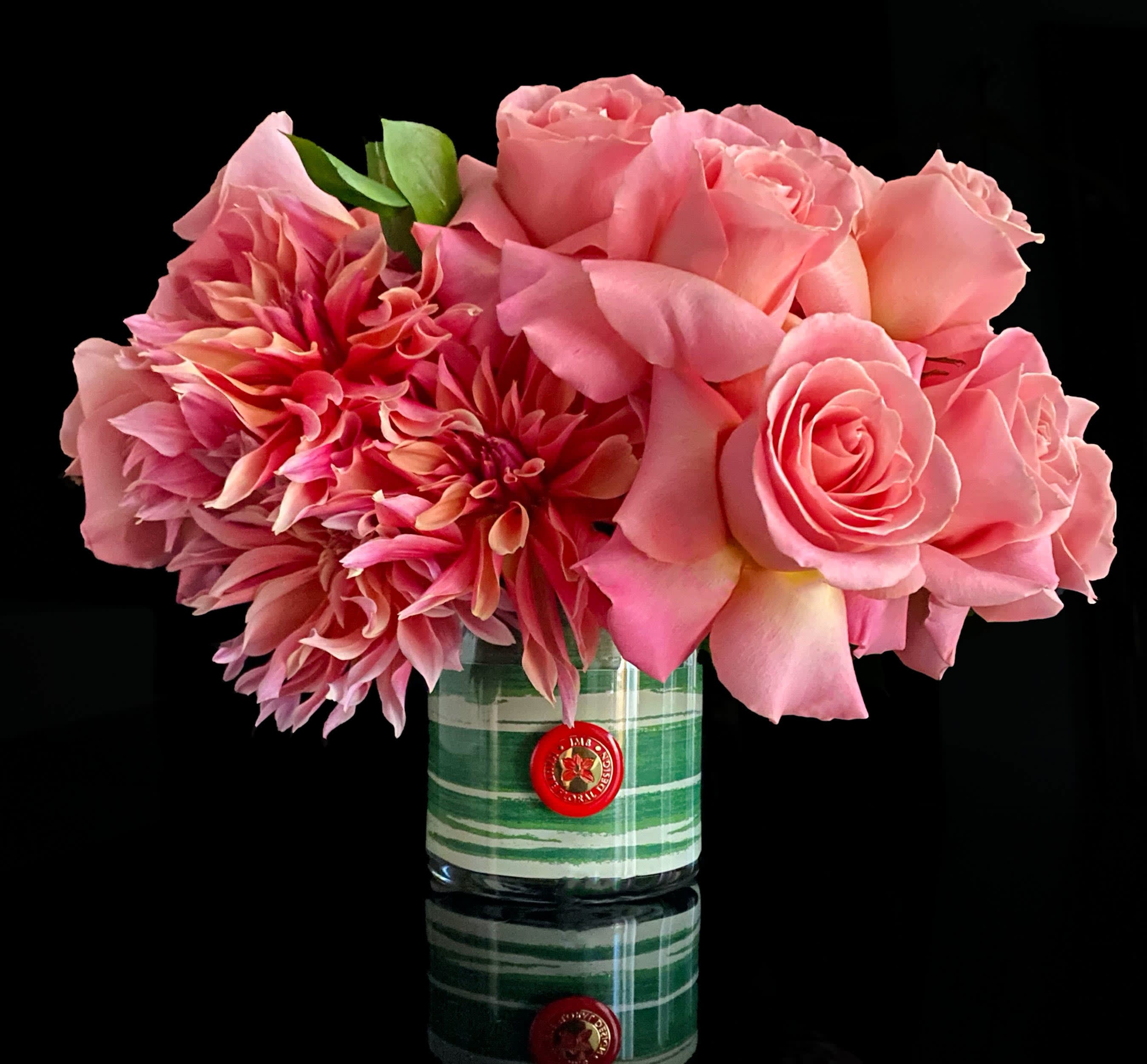 Hinsdale Flowers - In season focal blooms and roses in pink tones on a lined glass vase. Depending on season we will include Dahlia, Peony,Protea or orchids.