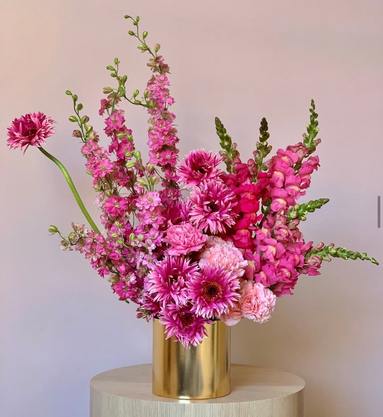 Pink Pop - &quot;Pink Pop&quot; is a vibrant and energetic explosion of color. This ultra modern arrangement features a bold selection of pink blooms, chosen for their striking shapes and saturated hues.  The overall effect is a joyful and eye-catching display of contemporary floral design.