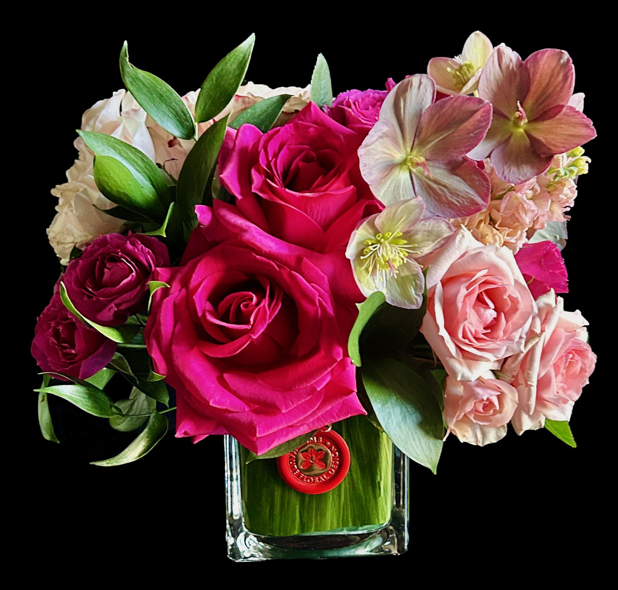 Compact Mixed Pink Blooms - Compact mixed roses with focal seasonal bloom in lined glass cube.