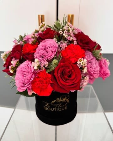 Forever Romance Box - Small Box (Standard)- 12 premium Ecuadorian  roses with assorted floral fillers  Medium Box (Deluxe)– 15 premium Ecuadorian  roses with assorted floral fillers  Large Box (Premium)– 24 premium Ecuadorian  roses with assorted floral fillers    ***Subject to substitutions based on seasonal or overall availability.***  Florist reserves the right to replace certain flowers in an arrangement with different ones if the one on the photo display is not available. Florist will strive to replace with alternatives that maintain the arrangement's original style, color palette, and overall aesthetic. Utilizing florals of  equal or greater value