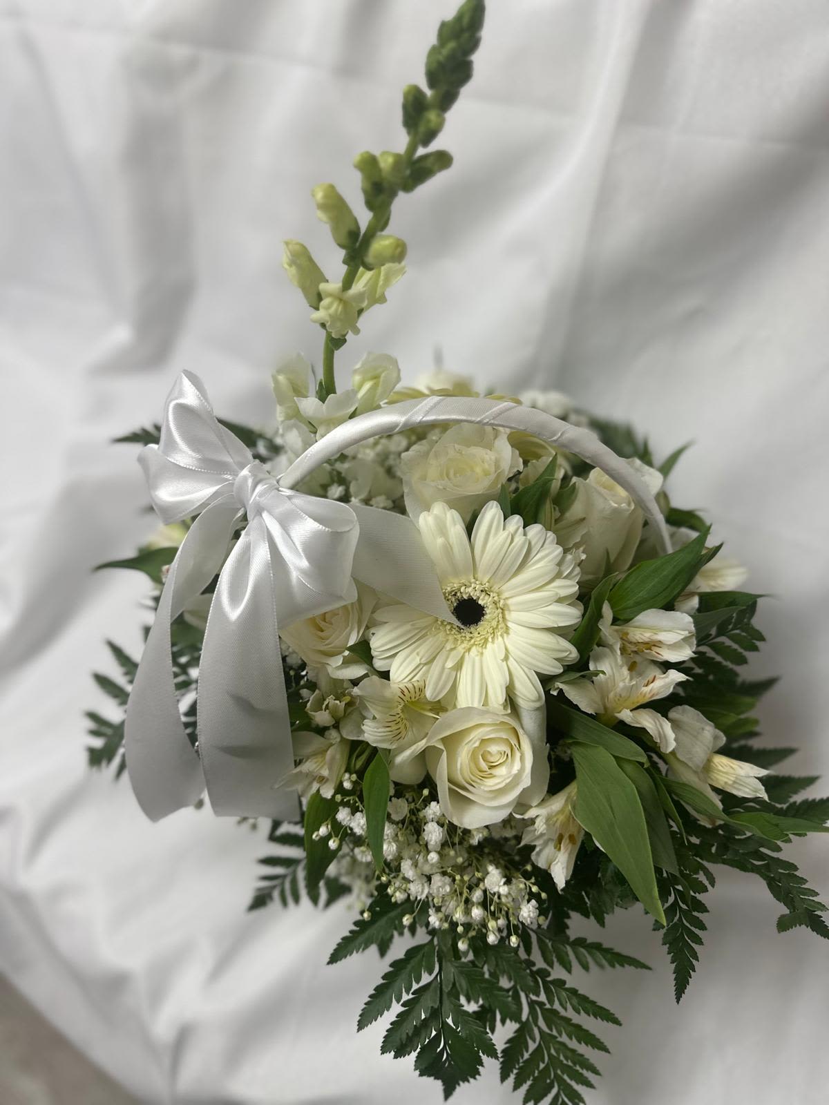 Light of the Soul by Clarita's  - A floral arrangement in soft tones with white and green accents, designed to offer comfort and accompany with respect during times of sorrow.