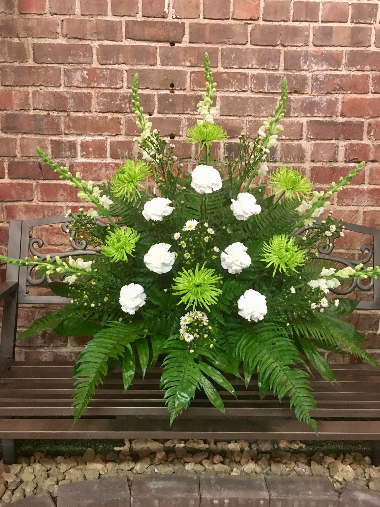 Tranquil Peace Sympathy  - Sympathy arrangement with green spider mums, white carnations, snapdragons and monte casino flowers. 