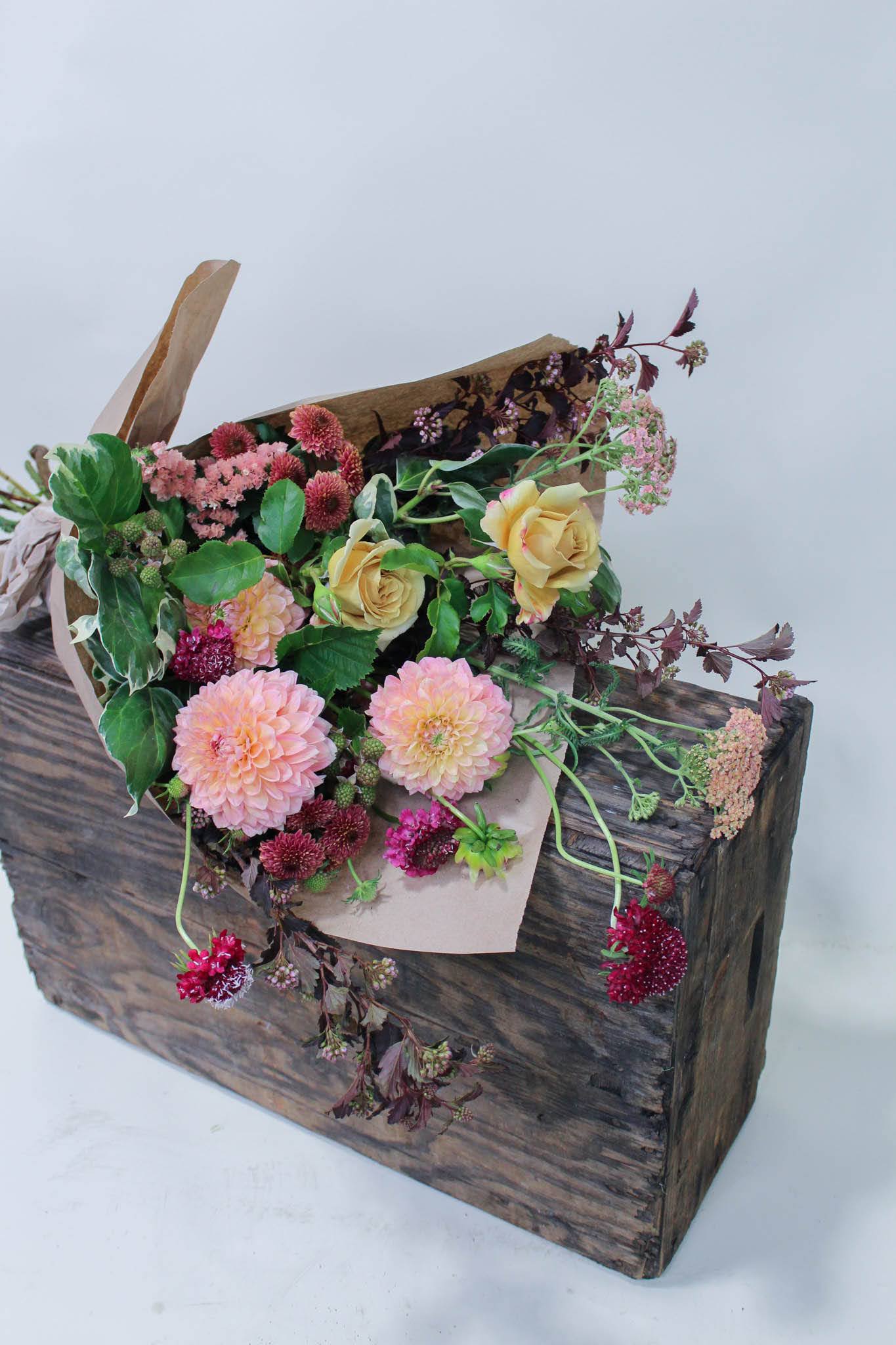 Wrapped Flower Bouquet: medium-large (For Pick-up Only) - This assortment of seasonally sourced blooms is ready for your vase. Hand held, beautifully wrapped and gift ready with a ribbon. For general requests, please leave our team a note during check out such as: &quot;loves peaches and burgundies&quot; or &quot;preferred pick up time (1pm)&quot;  *Images are a representation of this bouquet style. Flower selection may vary due to availability the week of your order.  *All arrangements are made to order and vary in flower selection. We only offer our wrapped flowers for pick up as they must be freshly cut and placed in water soon after leaving our shop.