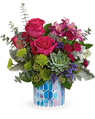 Teleflora's Watercolor Blooms Bouquet Teleflora's Watercolor Blooms Bouquet - Celebrate a job well done with this glorious pink rose bouquet and beautiful mosaic vase of stained glass--a keepsake they'll always treasure! Dark pink roses, dark pink alstroemeria, miniature purple carnations, green button spray chrysanthemums and blue sinuata statice are arranged with dusty miller, spiral eucalyptus, seeded eucalyptus and lemon leaf. Delivered in a Blue Beauty Mosaic vase.