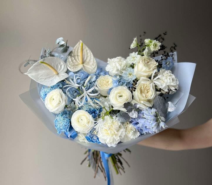 #44 Raya bouquet  - Elegant and serene, the Raya bouquet is a poetic blend of soft whites, icy blues, and airy textures — a floral composition that radiates calm, luxury, and clarity. Its sculptural form and cool-toned palette evoke a sense of quiet sophistication, ideal for meaningful moments and refined spaces.  