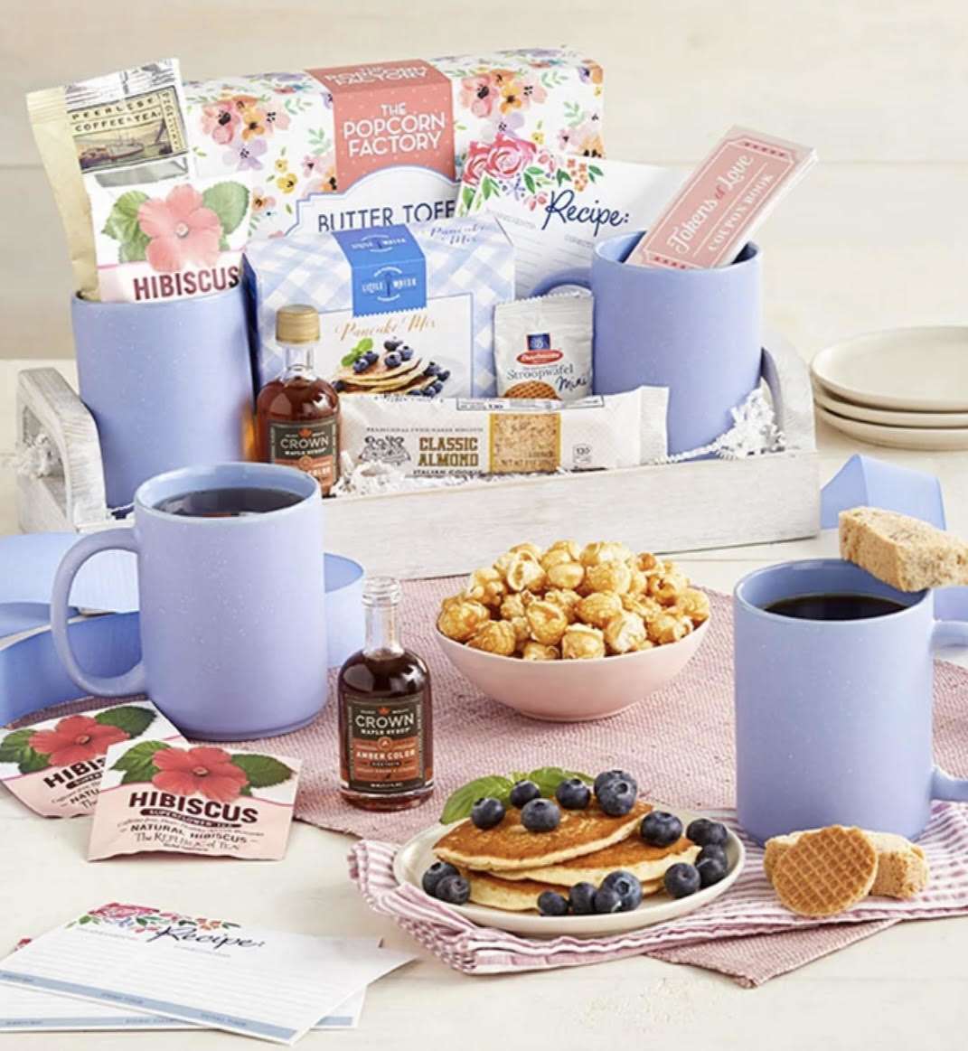 ***SALE****    Spring Breakfast Tray  - Make them eager to rise and shine with this charming breakfast tray of treats. Create an intimate experience for someone special with artisanal coffee and tea, a pair of ceramic mugs, pancake mix, and organic maple syrup. If whipping up pancakes isn’t on the morning menu, there are plenty more sensational snacks to enjoy including biscotti, mini stroopwafels, and The Popcorn Factory® butter toffee popcorn. It all comes neatly packaged in a wooden tray with convenient handles in case you want to spoil somebody with breakfast in bed. 