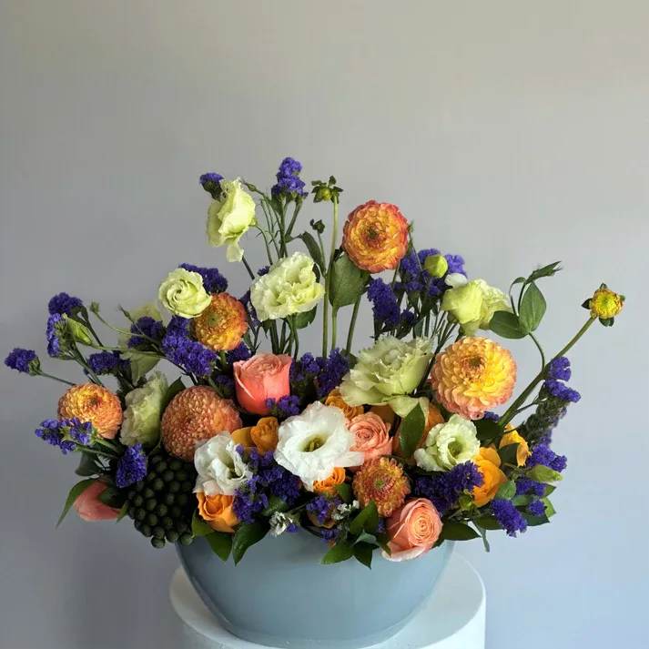 #27 Ashley - This beautiful arrangement of flowers of pure light color created to celebrate the most unconditional and purest form of love! shown an actual size &quot;Deluxe  Seasonal flowers can be replaced with a similar one. Vase and color of flowers can also be replaced with similar.