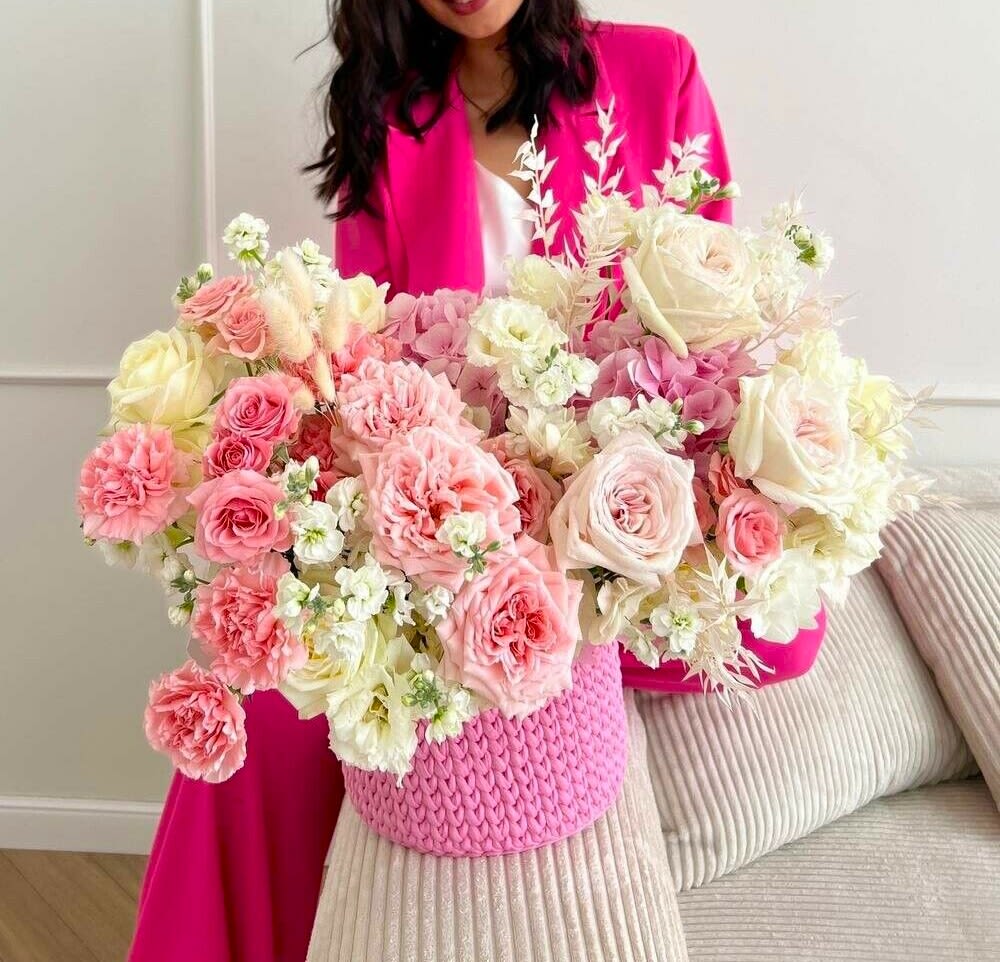 #41 Fiora Basket - Bold, feminine, and full of joy — the Fiora basket is a radiant celebration of beauty and confidence. Overflowing with lush pastel blooms in shades of blush, cream, and vibrant pink, this design brings energy and softness together in perfect harmony.  shown an actual size &quot;Deluxe&quot;  Seasonal or not available flowers can be replaced with a similar one. Boxes and baskets can also be replaced with others