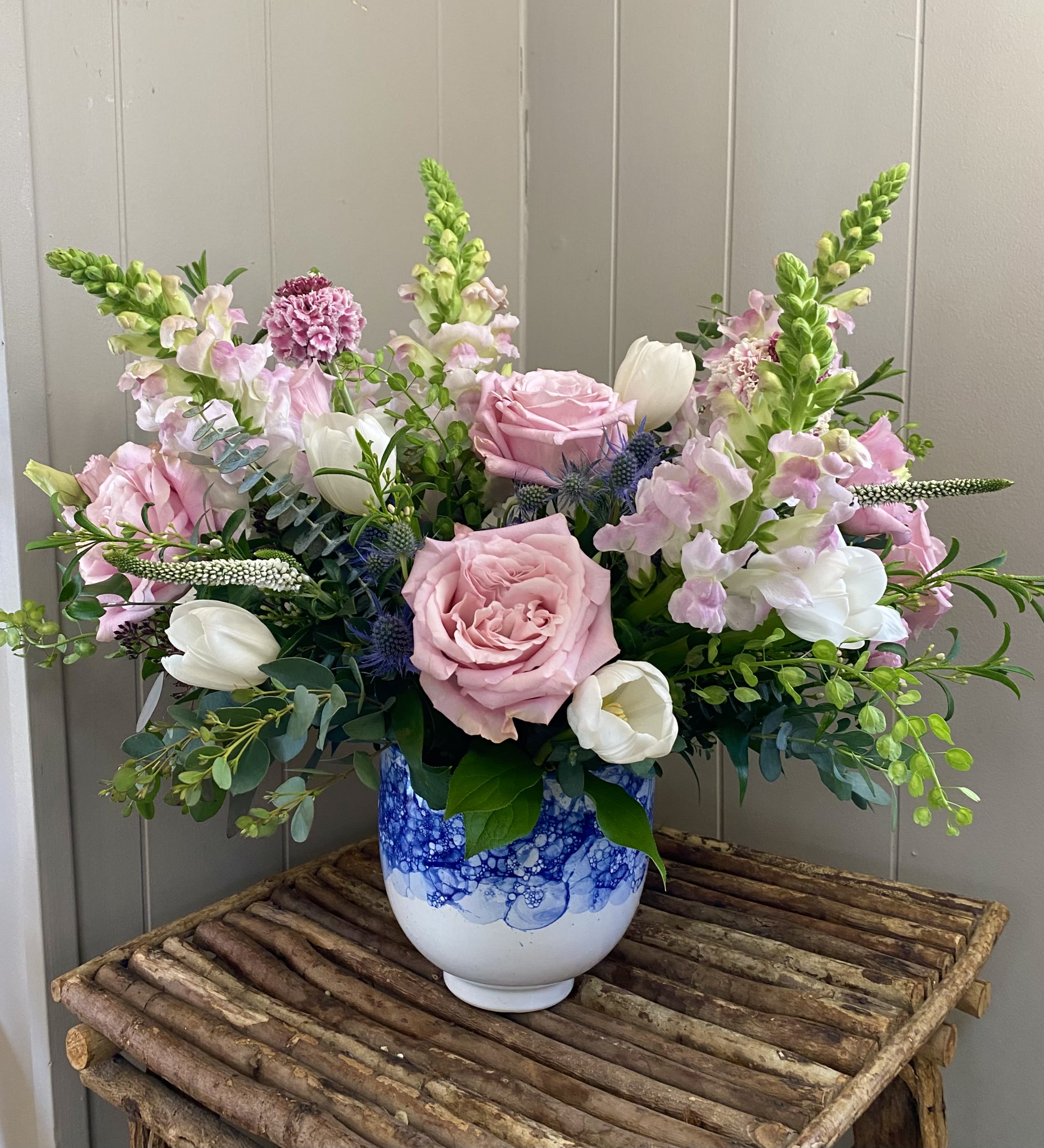 Angelite Angelite - This lovely garden assortment of snapdragons, tulips, lisianthus, scabiosa, roses and more is sure to bring spring time indoors!