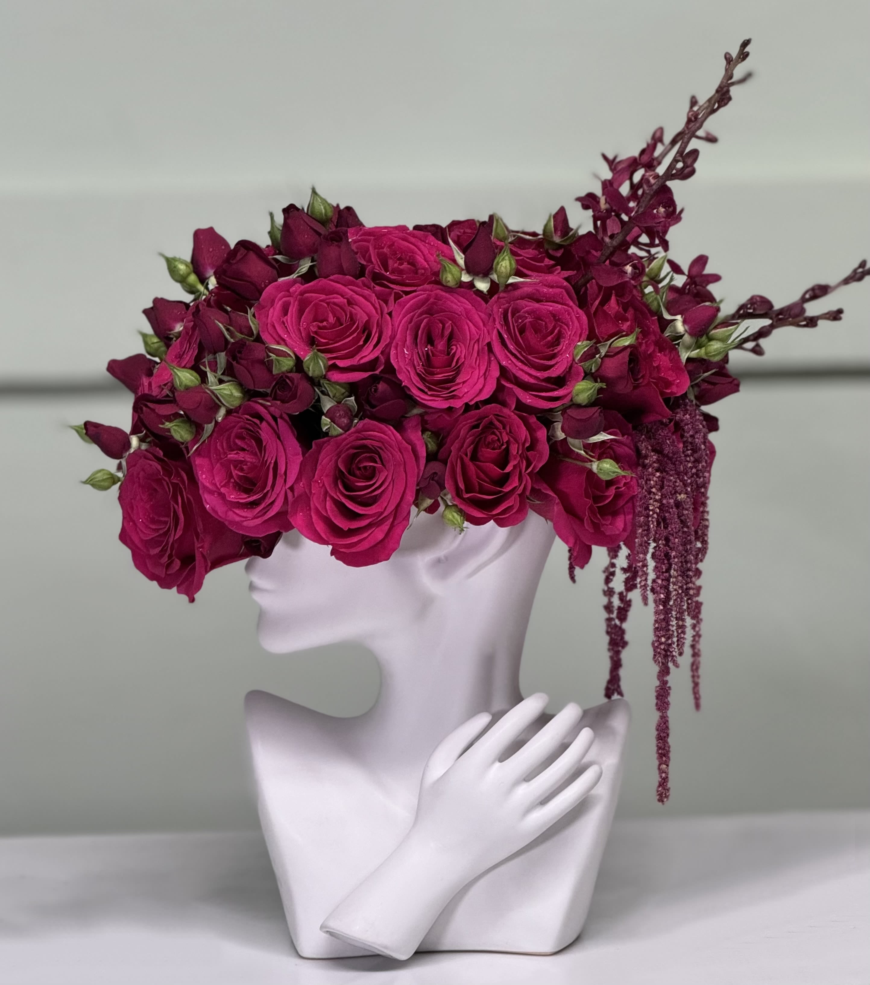 Elegant Lady Fuchsia Charm Elegant Lady Fuchsia Charm - Featuring a vibrant mix of hot pink and purple roses, this bright and cheerful floral crown is both playful and striking. It’s a perfect Mother’s Day gift for a mom who loves bold colors and modern floral styling. Arranged on a clean white mannequin head for a chic presentation.