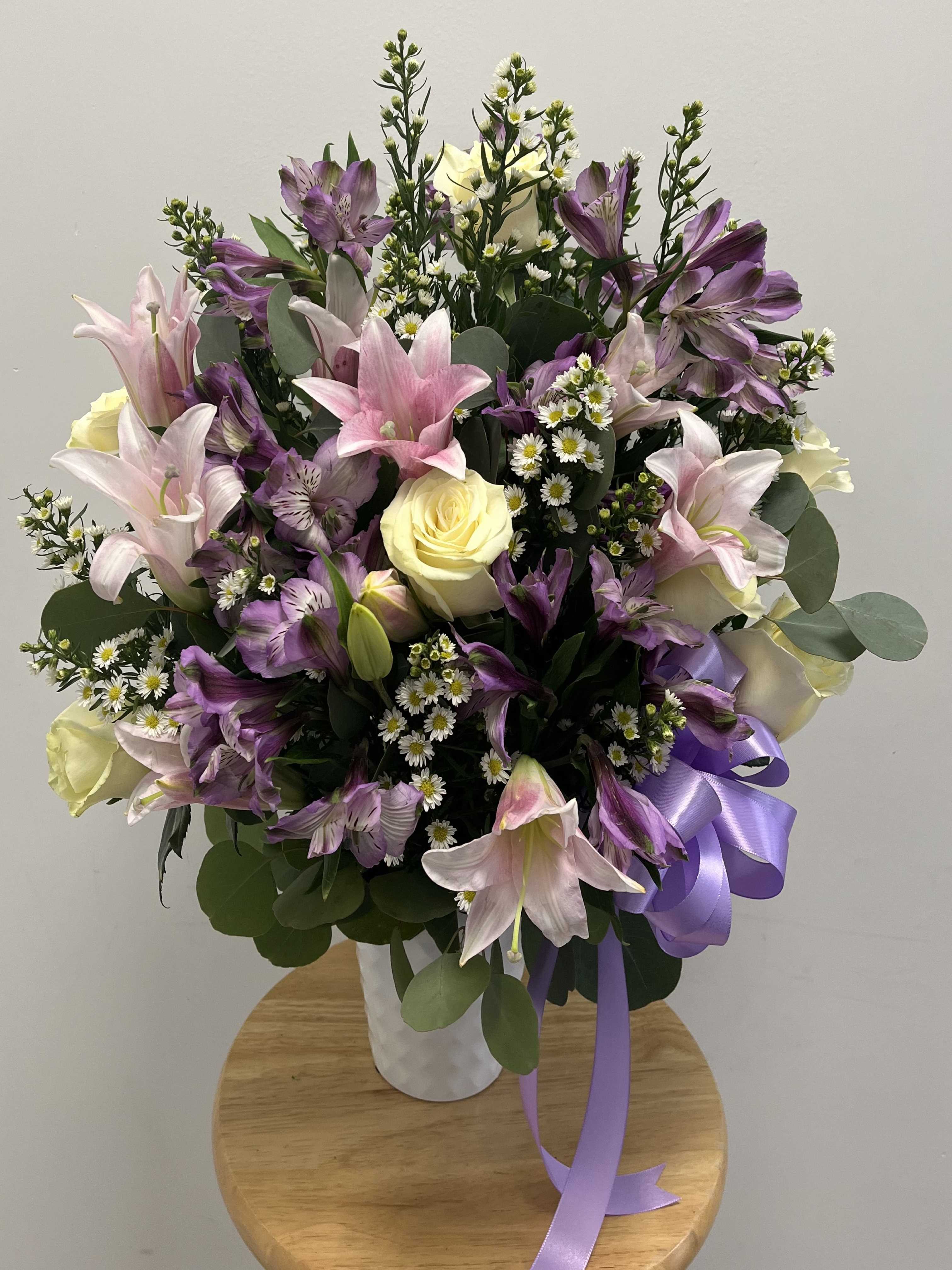 Warm Pink Lily Bouquet Warm Pink Lily Bouquet - Features pink lilies, white roses, white aster, purple alstroemerias, and silver dollar eucalyptus.