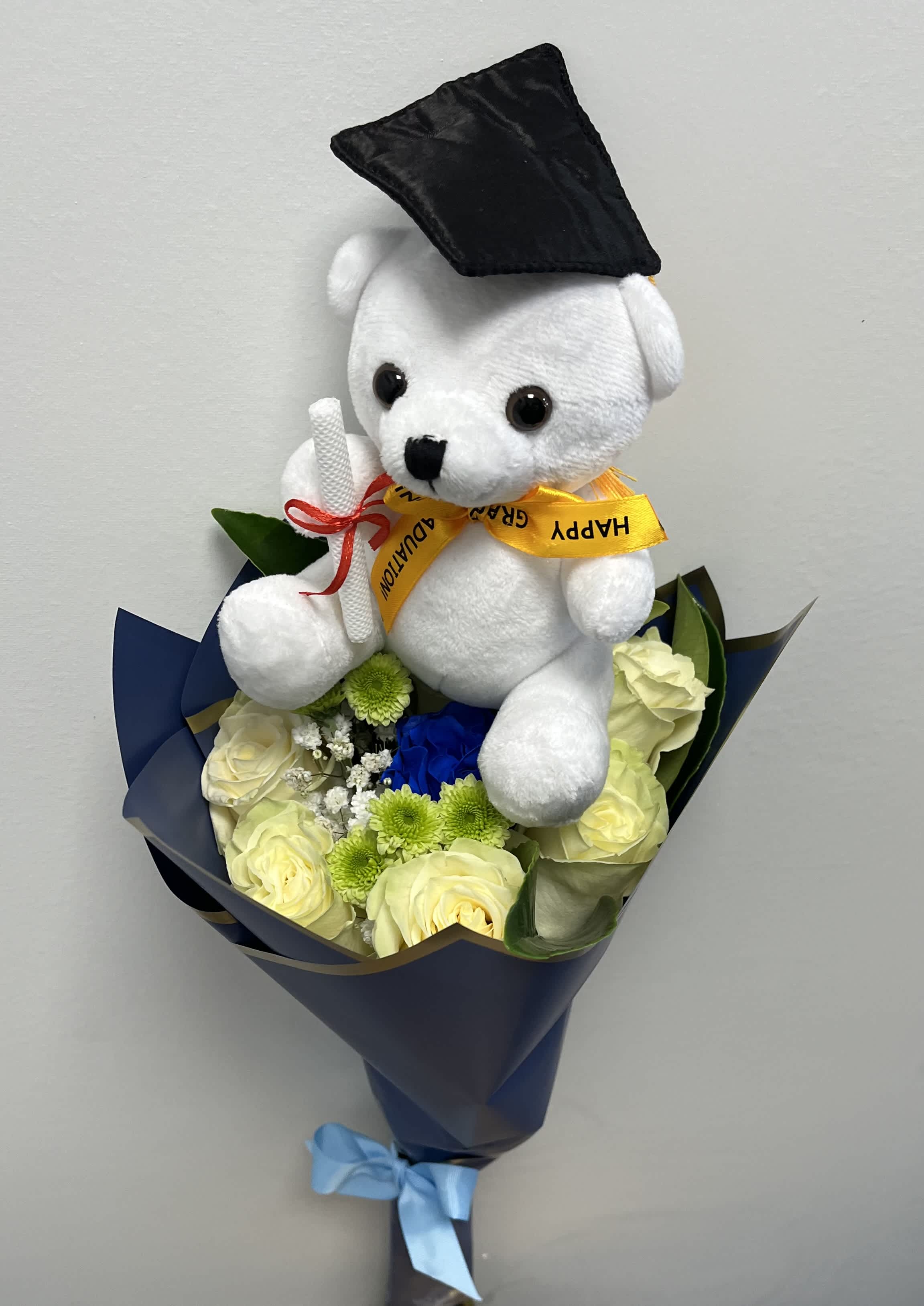 White and blue roses bouquet with Teddy Bear White and blue roses bouquet with Teddy Bear - Six white roses and one blue, baby breath, garden mum with teddy bear for graduation