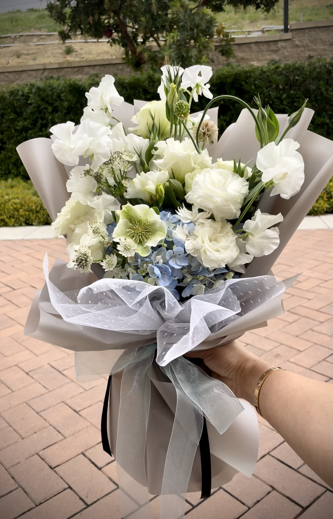 Serenity Bouquet  - This artfully arranged bouquet is made with soft greens and blues. Offering a mix of seasonal hand selected premium flowers, the Serenity Bouquet will be sure to bring elegance and grace to your lucky recipient.    We suggest that the bouquet be kept in its wrapping and placed in a clear vase.