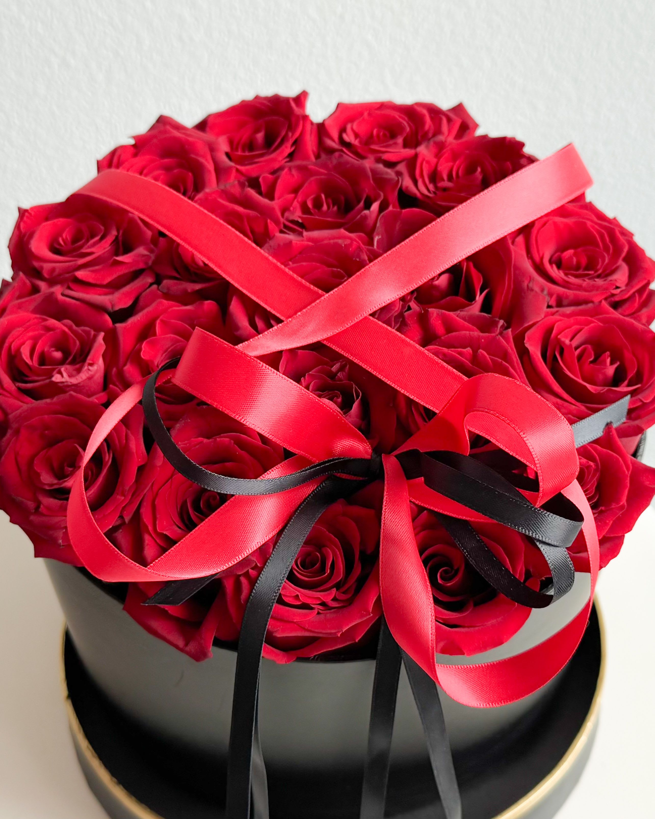 BBR  - Okay, folks, this right here is the ultimate statement piece. Deep red roses packed into a sleek black box, tied up with bold satin ribbons—this isn’t just a floral arrangement; it’s pure power, romance, and class in one. It’s giving luxury, it’s giving passion, and it’s giving I know how to impress. You wanna show love, respect, or just flex a little? This is it.