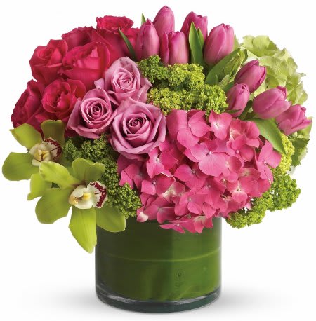 New Sensations Design New Sensations Design - A modern arrangement featuring a vibrant blend of hot pink and lime green blooms arranged into a lined glass vase,