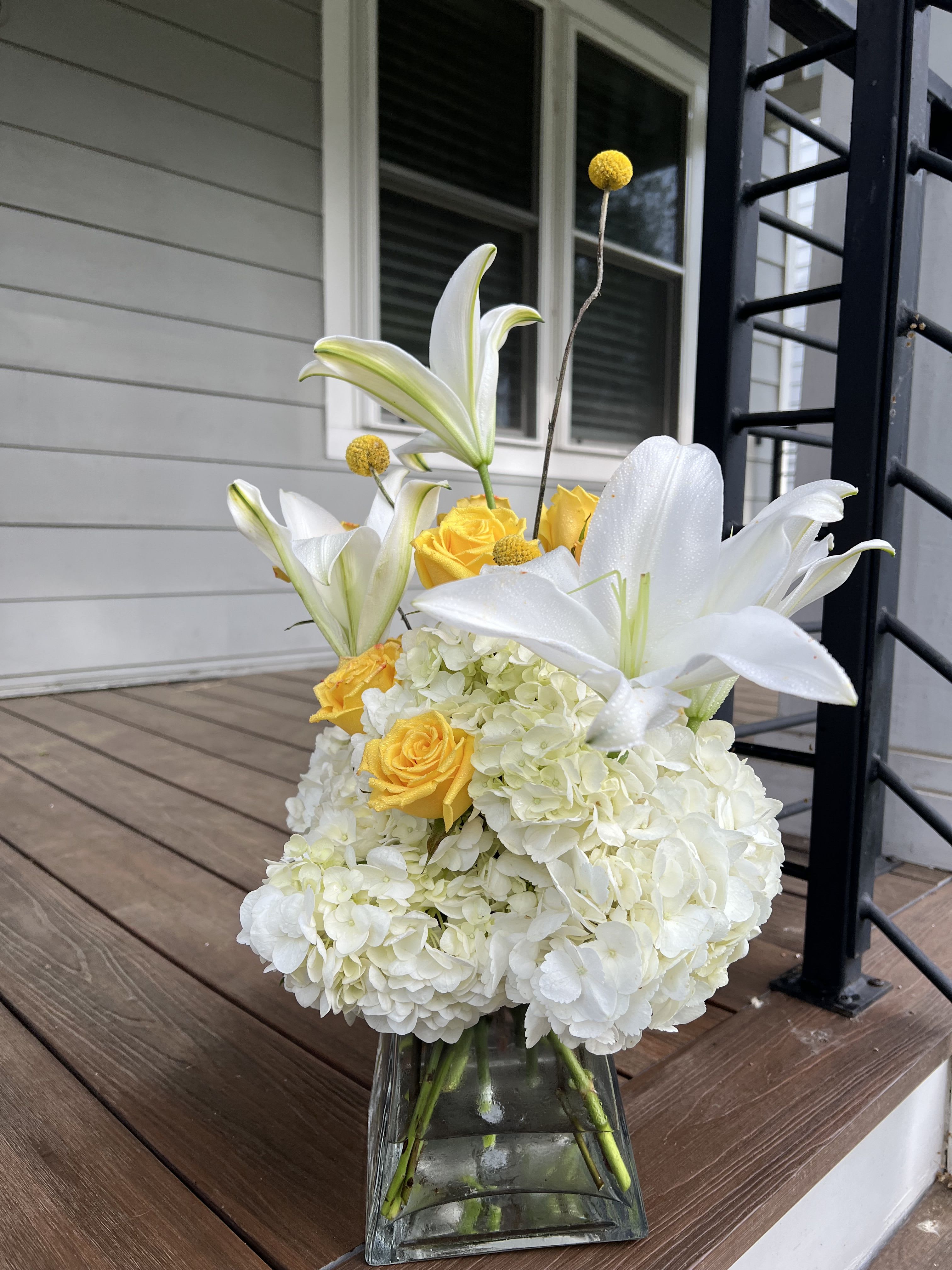 The Golden Touch The Golden Touch - An opulent arrangement of lush white hydrangeas, fragrant white Oriental lilies, radiant yellow roses, and golden craspedia — a sophisticated blend of elegance and charm