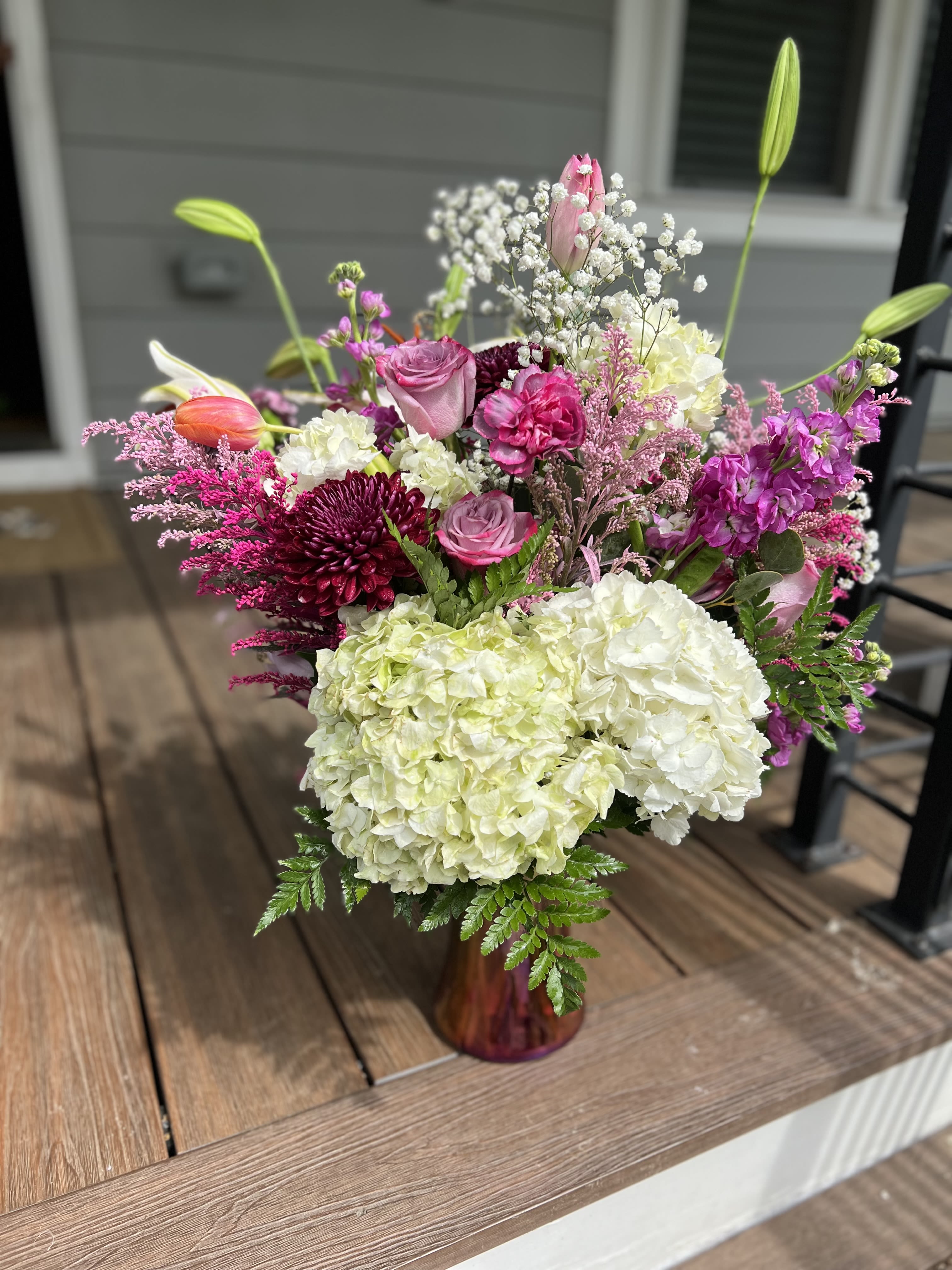 Pop of Petal Pop of Petal - A lavish medley of hydrangeas, vibrant multicolored solidago, elegant lilies, chrysanthum,, and classic roses — artfully arranged to exude timeless beauty and refined splendor.
