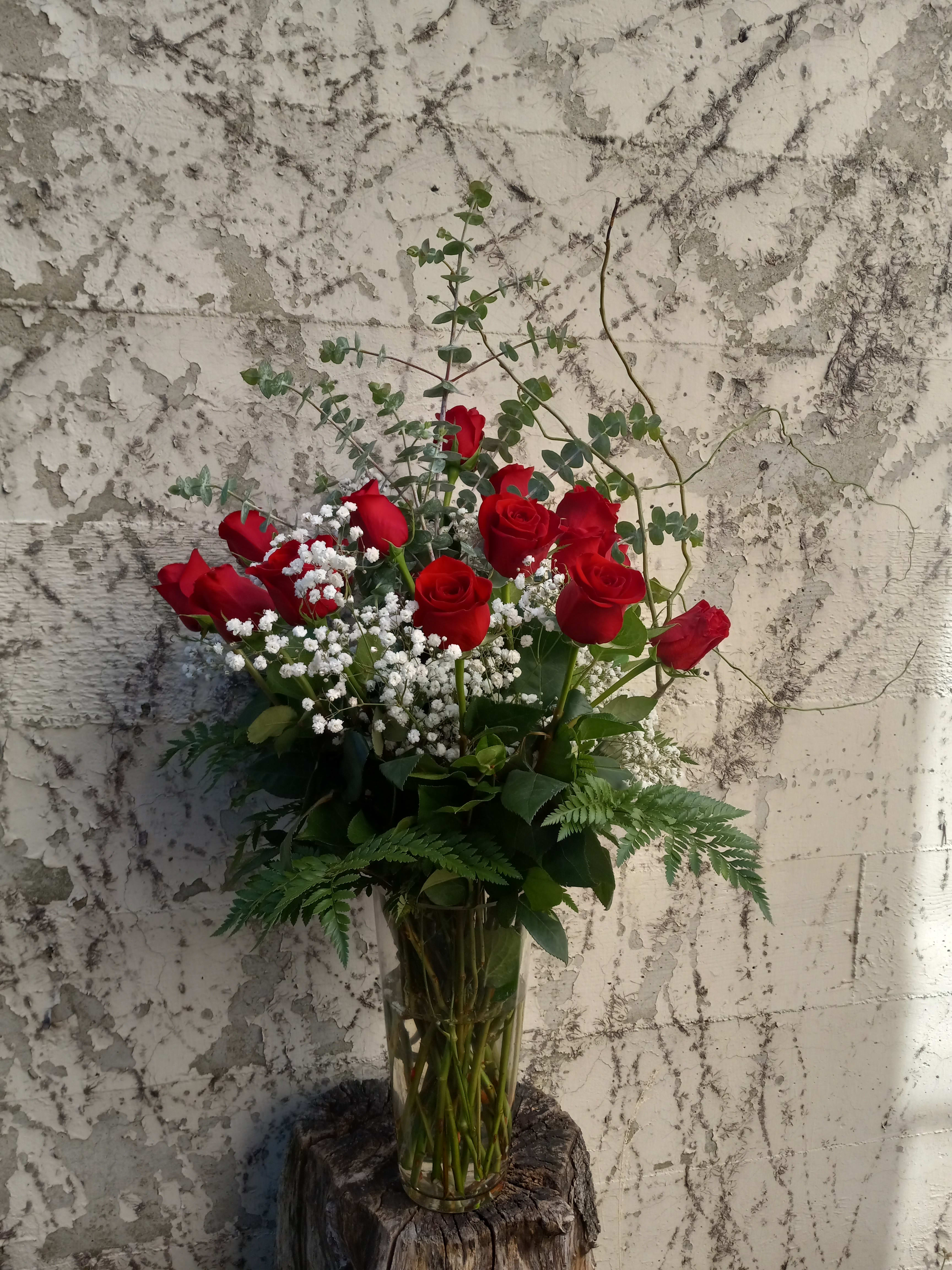 Classic Red Long Stem Roses Arranged by HallidayFlowers - This is a vase of a dozen red roses elegantly arranged in a vase. 