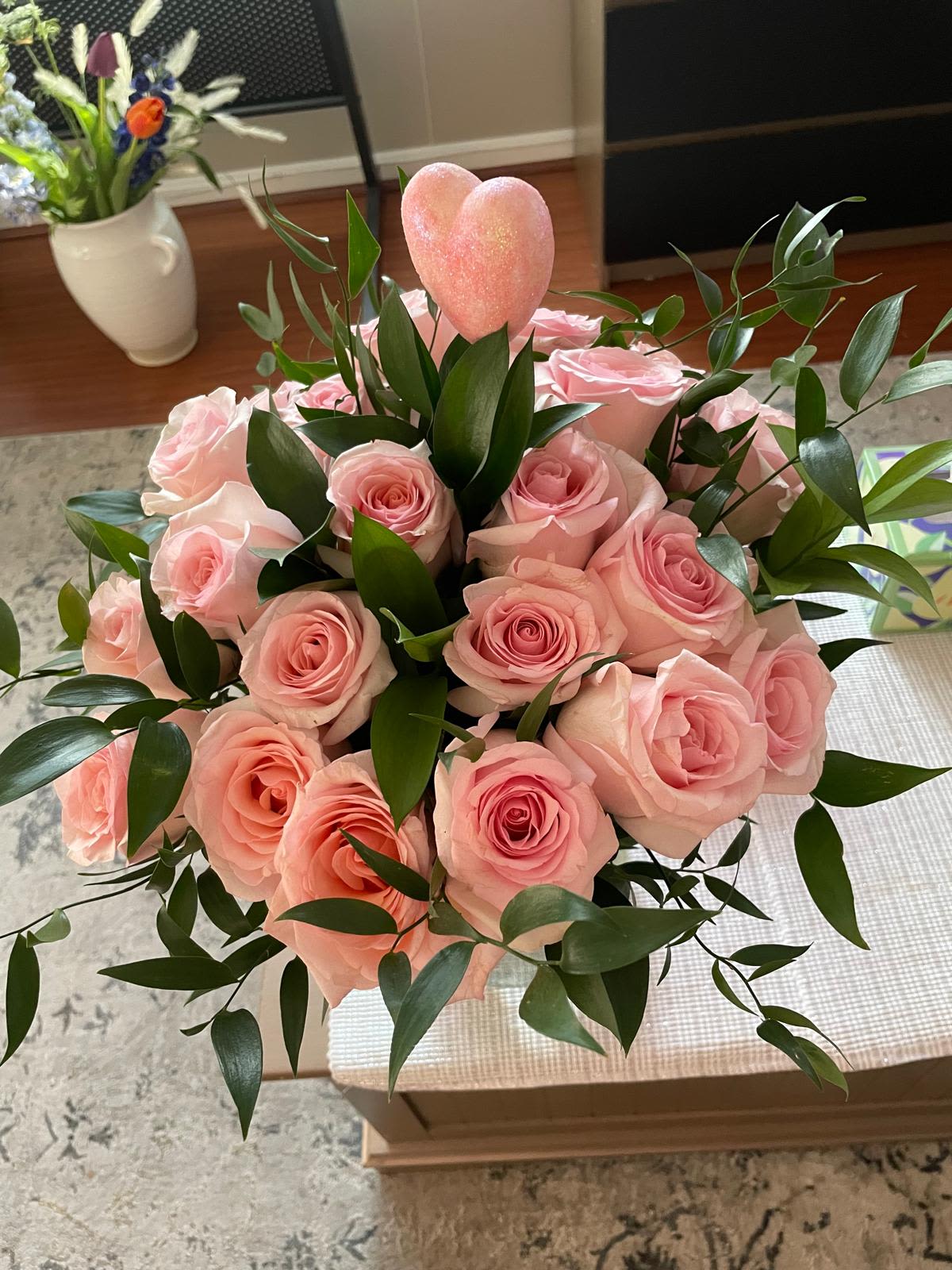 Sweetheart Bloom Sweetheart Bloom - A romantic and delicate arrangement of soft pink roses nestled among lush greenery, crowned with a sparkling pink heart. This charming design is the perfect expression of love, making it ideal for anniversaries, Valentine’s Day, or simply to say, “You have my heart.”