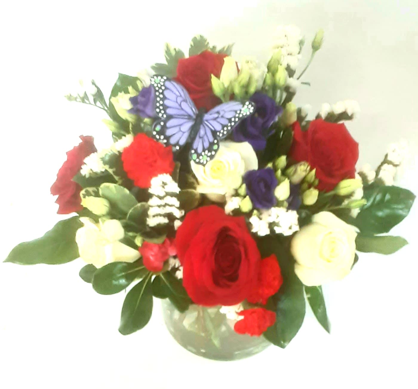 Red white and blue celebration - Red roses and assorted white flowers with a blue butterfly