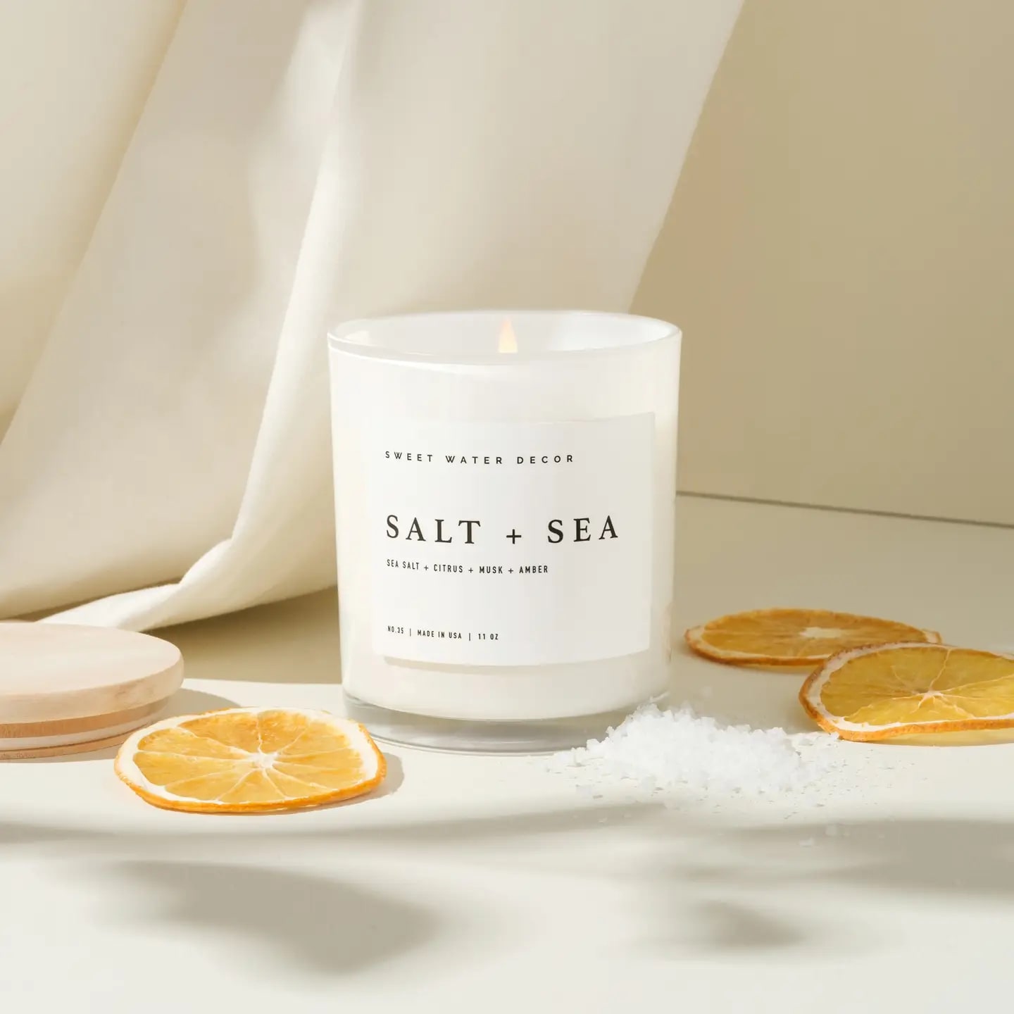 Salt + Sea 11oz Soy Candle - Sweet Water Decor-Salt &amp; Sea Salt and Sea is our best-selling scent for a reason. It captures the sophistication and refreshment of a serene coastal evening. Our white jars fit any home decor style.  SCENT NOTES: • Top: Sea Salt, Citrus • Middle: Musk • Base: Amber  CANDLE INFO: • Size: Volume 11oz | 214g Net Weight | 3x3x3.5&quot; • Burn Time: 50+ Hours • Wick: 100% Cotton (Lead and Zinc Free) • Wax: Proprietary Soy Based Wax Blend | Vegan, Non-GMO, Kosher • Premium Fragrance Oil • Gluten Free, Phthalate Free, Non-Toxic • Made in Pittsburgh, PA 