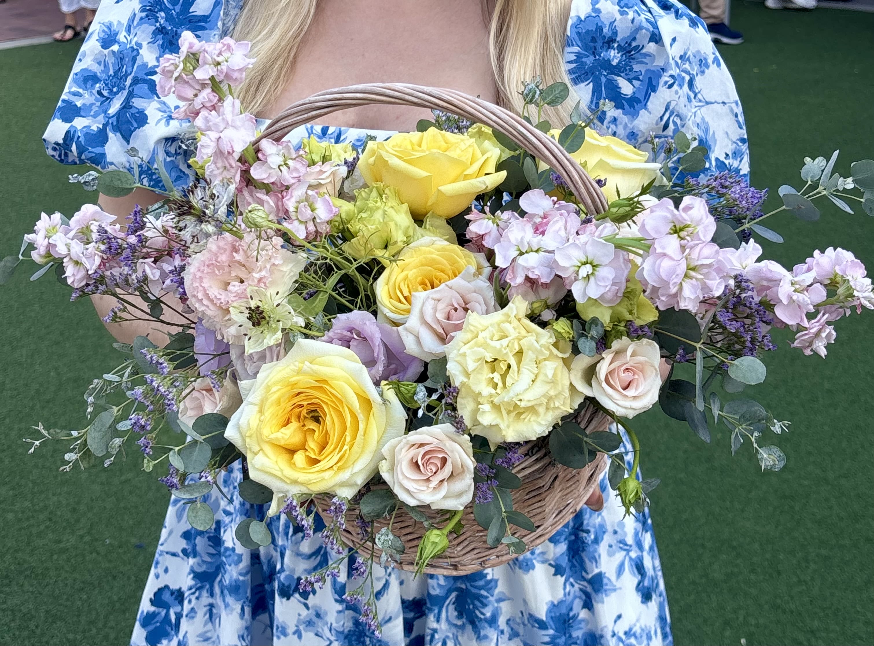 Bluebell Picnic Bluebell Picnic - Soft, graceful, and freshly gathered, Bluebell Picnic brings the romance of an English countryside into a charming wicker basket. With buttery yellow roses, blush lisianthus, lavender sprigs, pale pink garden roses, and wisps of eucalyptus and statice, this bouquet feels like a floral daydream beneath a summer sky. Perfect for birthdays, brunches, or spontaneous gestures of beauty and love. Style: Light, romantic, whimsical Fragrance: Soft floral with fresh garden notes