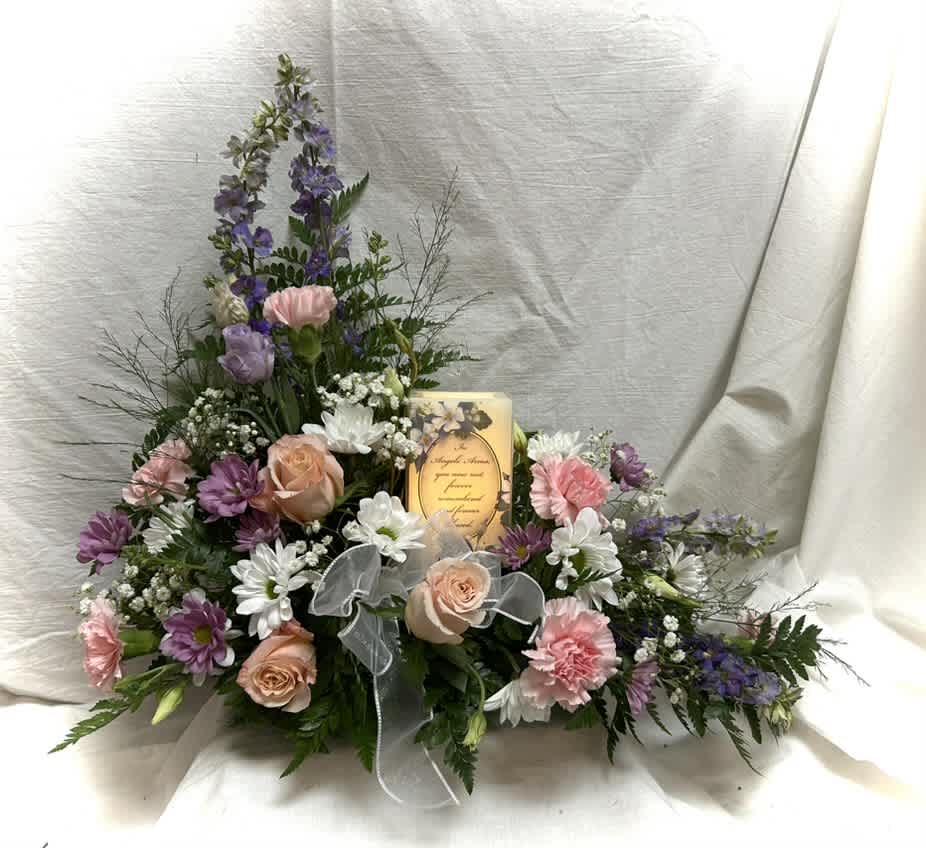 Stylized sympathy candle arrangement Stylized sympathy candle arrangement - Beautiful fresh flower memorial arrangement with a square wax timered candle. Contains roses, carnations with colorful line flowers and fillers. Colors may vary.