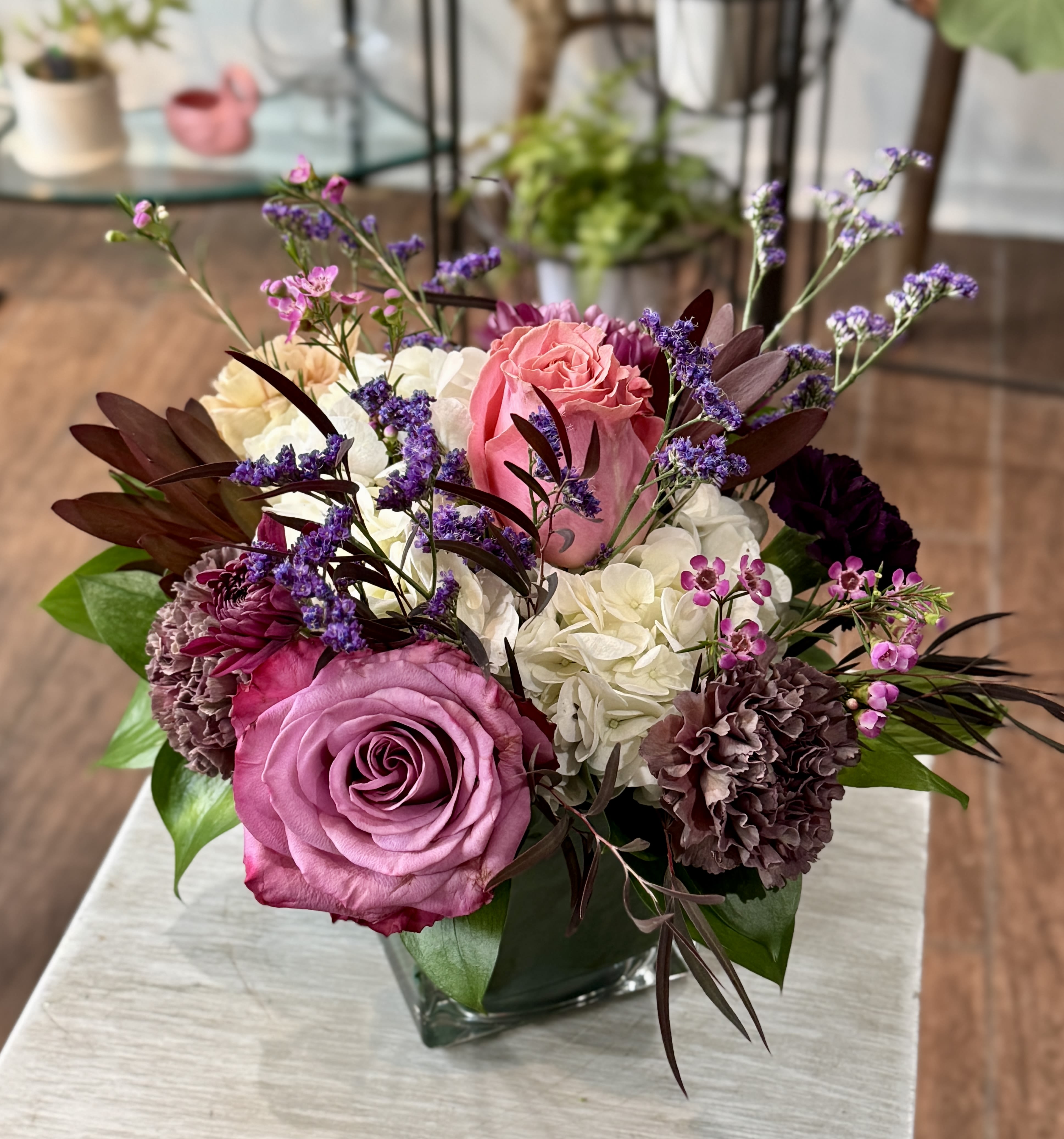 Mabel - A delightful and fluffy mini arranged in a clear glass vase.