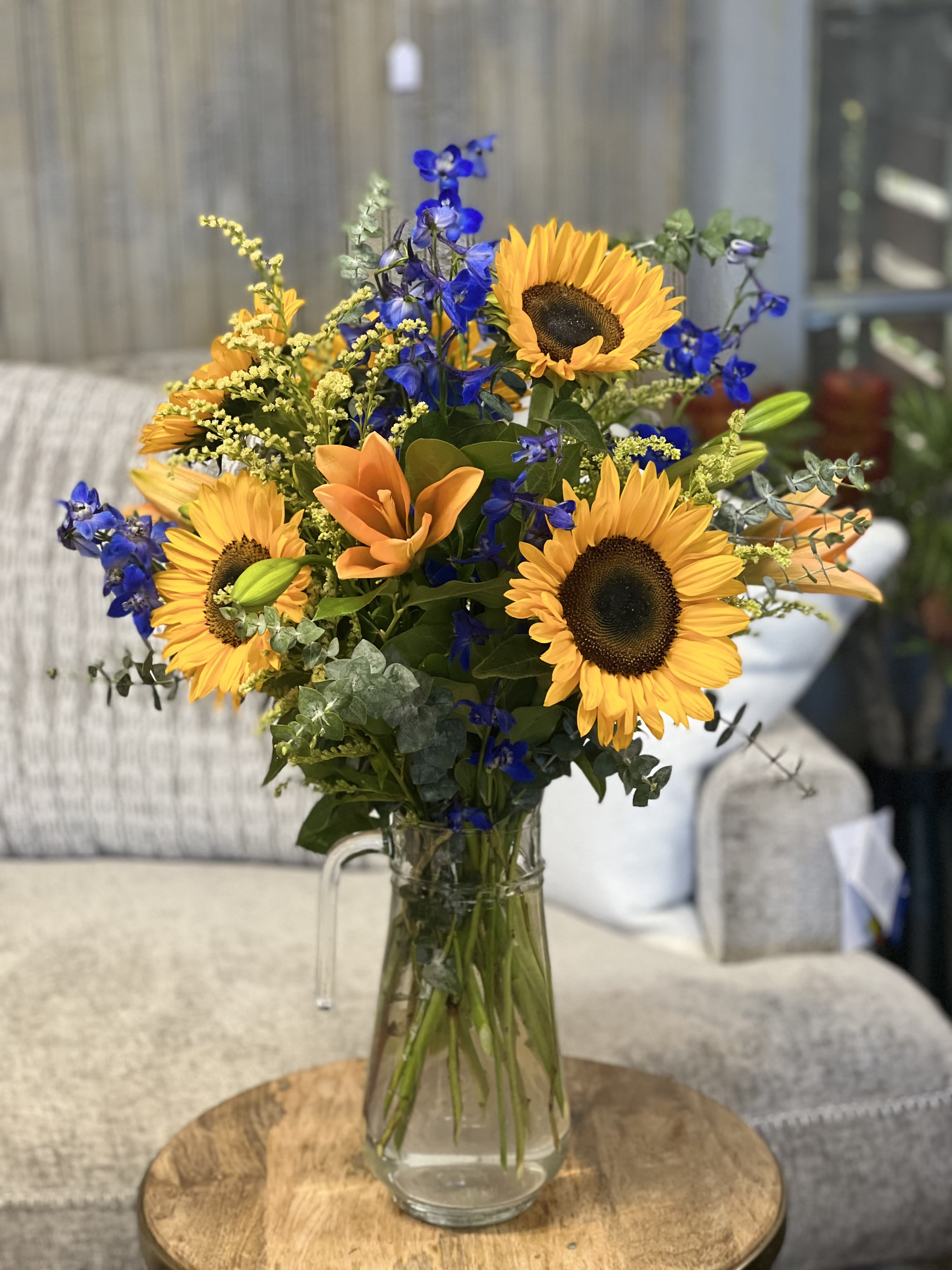 Pitcher Perfect - THIS COLORFUL GLASS PITCHER BRINGS ALL THE COMFORTS HOME. PERFECT ACCENT FOR ANY OCCASION OR PARTY.  (image subject to substitutions depending on availability; color scheme and over all feel of arrangement is similar as possible)