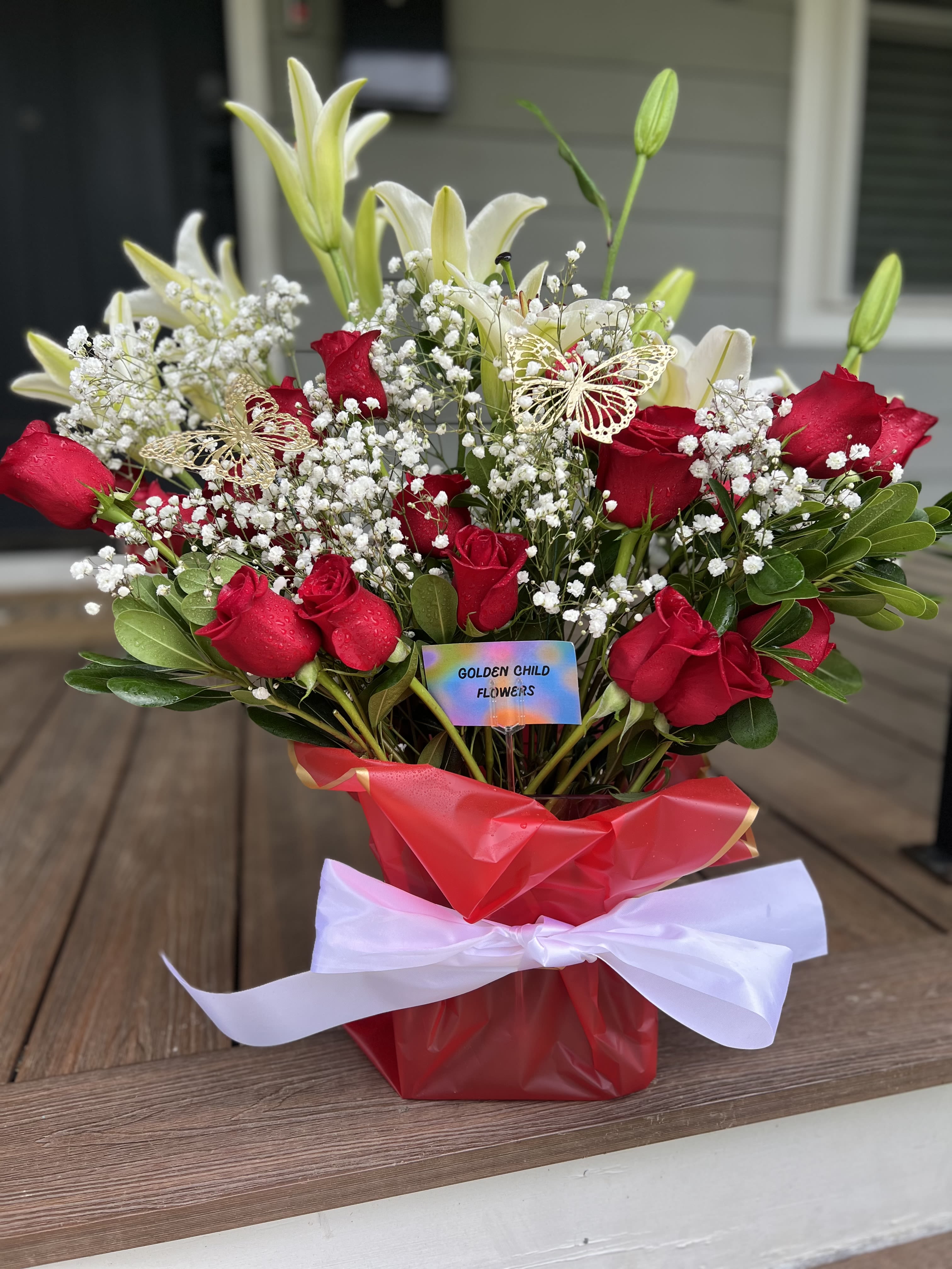 Crimson Devotion - A breathtaking display of love and elegance, Crimson Devotion features two dozen velvety long-stemmed red roses paired with lush, fragrant lilies. This luxurious arrangement blends passion and purity, making it the perfect statement for anniversaries, romantic gestures, or unforgettable moments. Designed to captivate and impress, this bouquet says everything without a single word