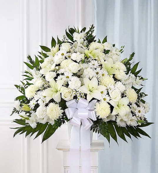 Sympathies White Funeral Standing Basket Sympathies White Funeral Standing Basket - Symbolizing peace, serenity and purity, white flowers can help comfort those grieving the loss of someone they loved dearly. Our majestic standing basket arrangement in angelic white is an impressive tribute to their memory. Artistically designed by expert florists with an abundance of pristine white blooms, it is a heartfelt expression of your deepest sympathies.
