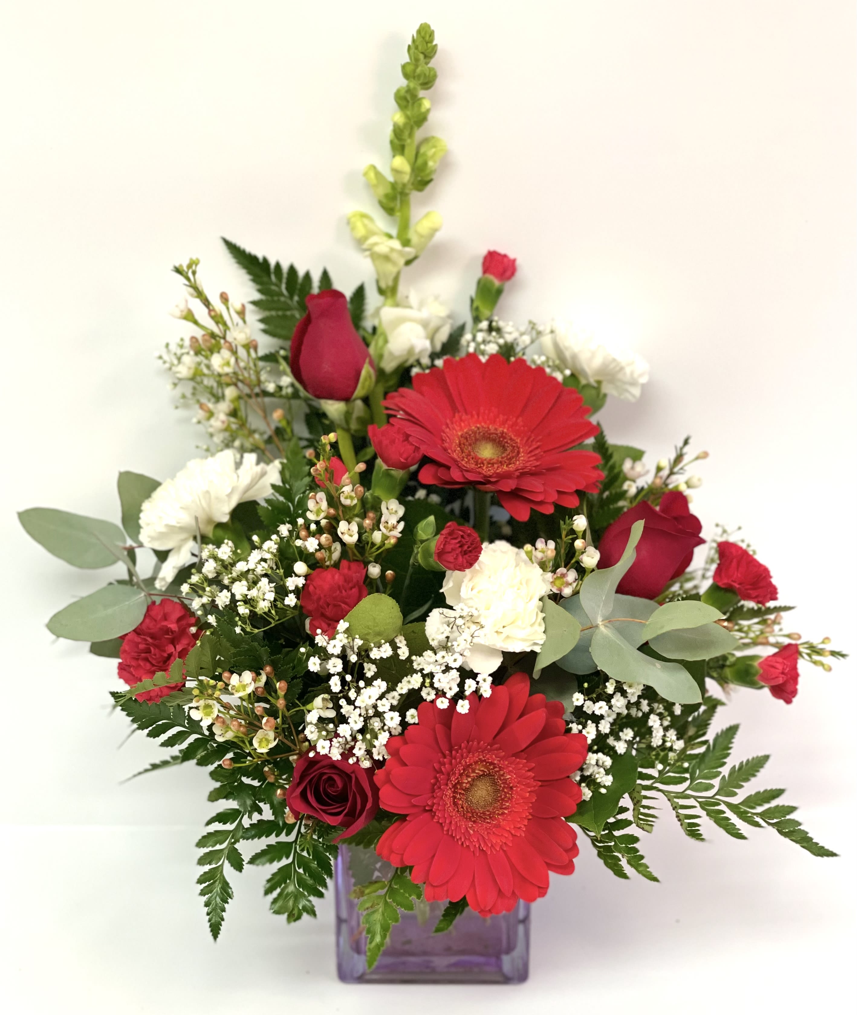 Cupid By Barb’s Flowers Cupid By Barb’s Flowers - Can’t help but fall in love with this bouquet. Red Gerber daisies, Red Roses, Carnations, Snapdragons and fillers.