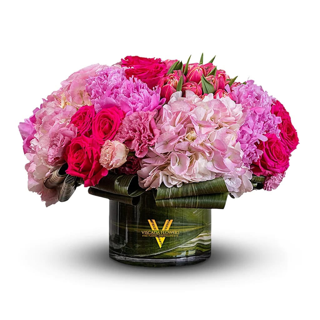 Bayberry Blush - Delicate and romantic, this bouquet features pink and white roses, light pink hydrangeas, pink tulips, and greenery. With its soft hues and graceful blooms, Bayberry Blush adds an enchanting touch of beauty and elegance to any space.