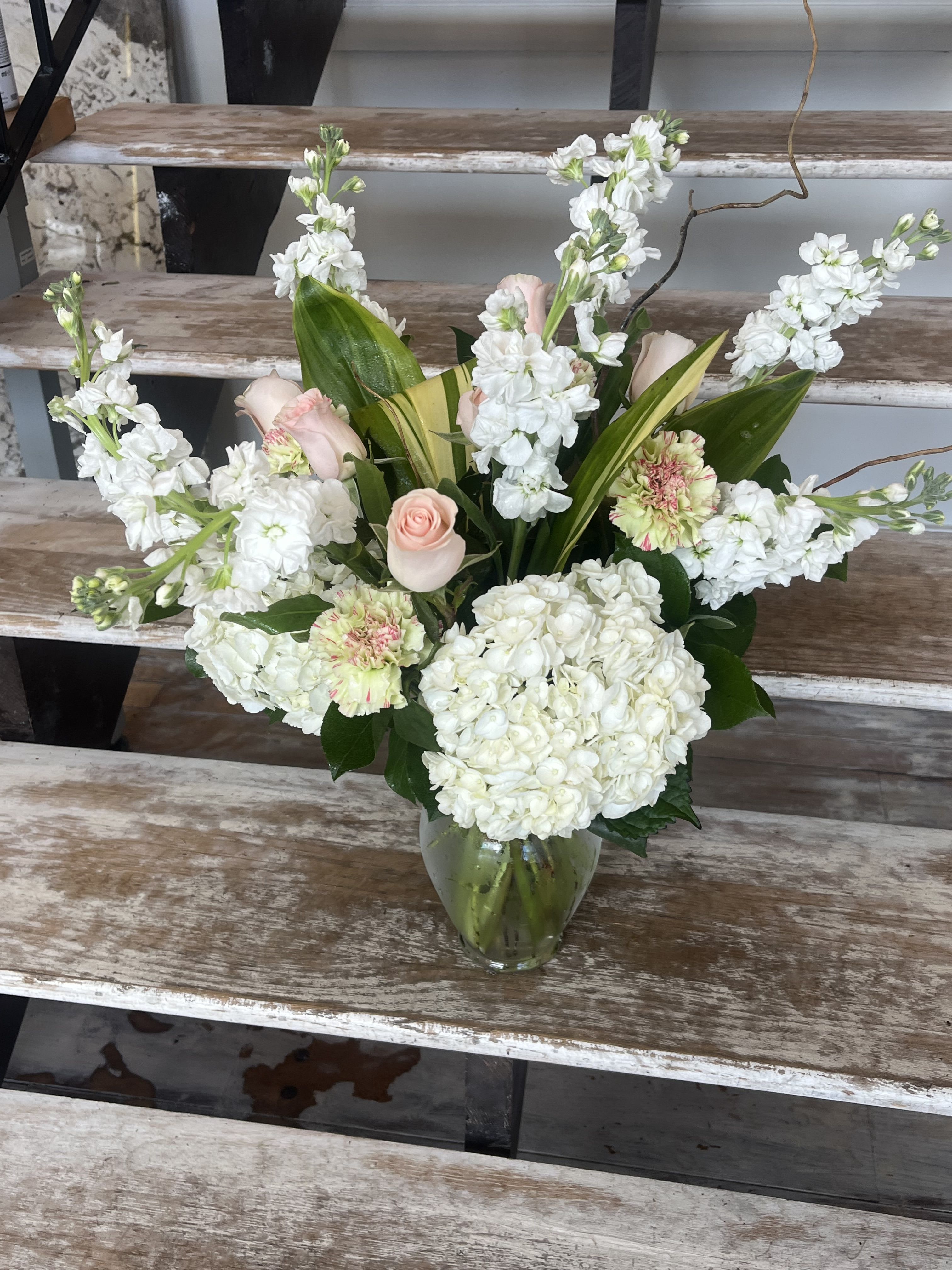Clear Skies - Let this uplifting arrangement be reminders of the clear skies ahead. Capturing the feeling of hope that a new day brings, this bouquet is composed of voluminous hydrangea blooms, soft Roses, and calming Carnations to refresh their mood.