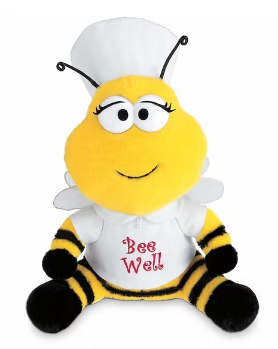 Bee Well Bee Plush (by Teleflora) Bee Well Bee Plush (by Teleflora) - We have just the cure for what ails them. A plush nurse bee is ready to buzz into service with enough fresh flowers to make anyone perk up. Details: Material: plush Dimensions: 10 1/2" h x 5" w