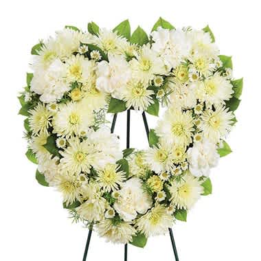 Heart Standing Spray - All White - Small and Medium - Express heartfelt thoughts of sympathy in a special way with this open heart standing wreath made of carnations, cushion, roses and Monte Casino blooms on a wire easel. Small Measures 15&quot;H X16X&quot;L. Large Measures 20&quot;H X 20&quot;L.