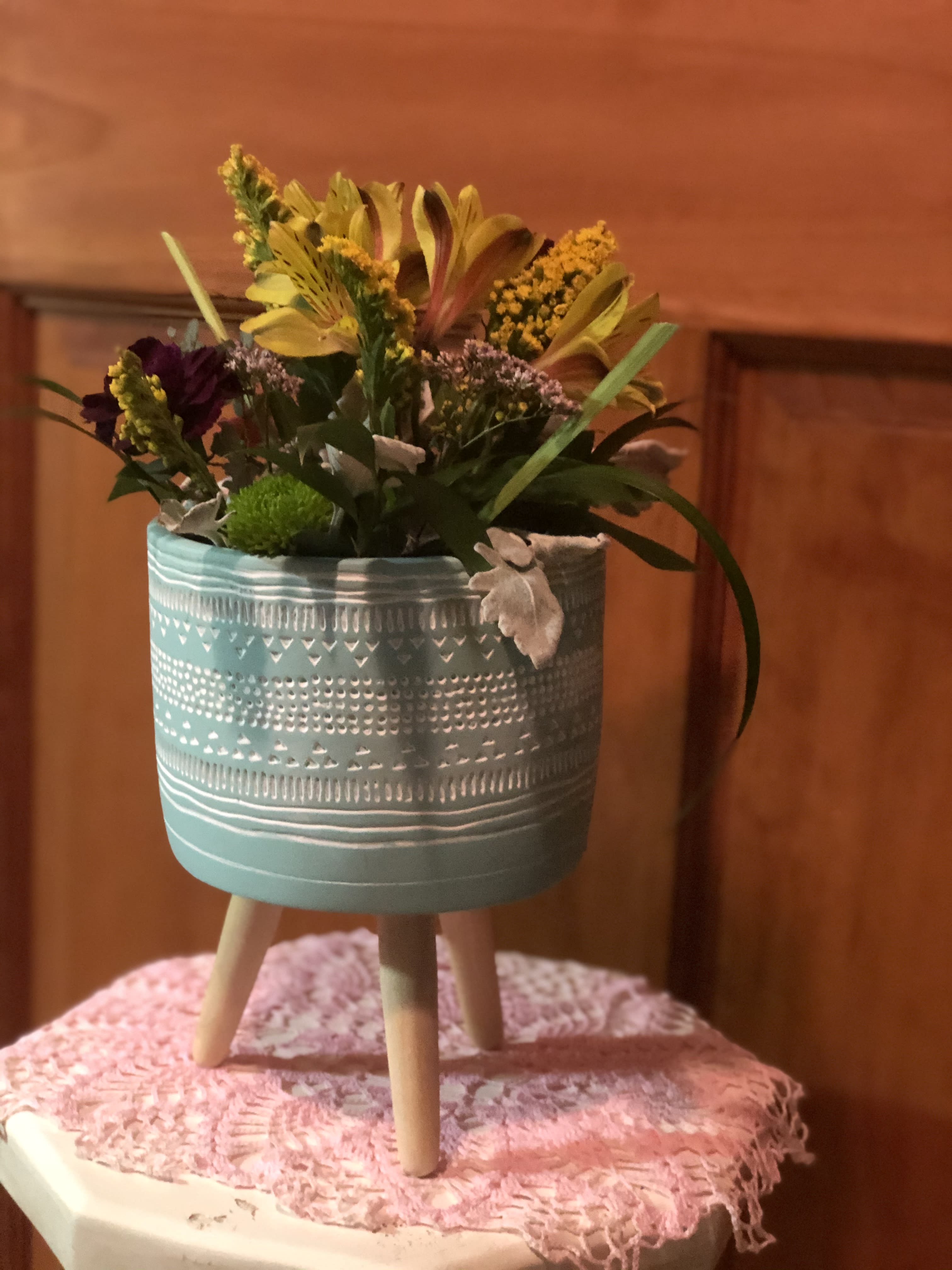 Zen Blossoms - Our Zen Blossoms combines the freshest flowers of the season in a  Mayan Blue Legged Pot(1) or white floral accented pot (2) that can be reused after the blooms have faded. Can be used to plant a succulent or miniature plant. Great for desk-top or table-top. We used Sunny Alstroemeria, mini Carnations, Morning Glory Solidago, Dusty Miller and assorted greenery. The first picture, with flowers container is no longer available. Please see other containers to the bottom of this one. Inventory count: 3