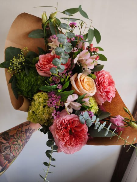 Hand-Tied Bouquet #1 Hand-Tied Bouquet #1 - A charming and elegant hand-tied bouquet featuring lush coral and peach garden roses, soft blush alstroemeria, and delicate clusters of purple waxflower. Accents of green hydrangea, mossy greenball dianthus, and wispy eucalyptus add freshness and movement!