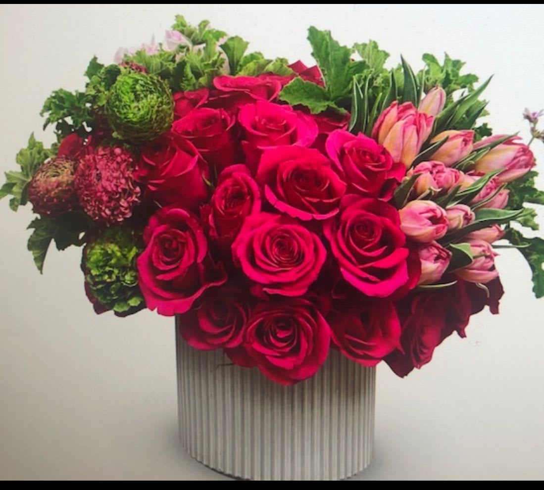 You look Hot - Gorgeous hot pink rose arrangement in a modern ceramic container, green hydrangeas, hot pink spray, cabbage flowers and tulips 