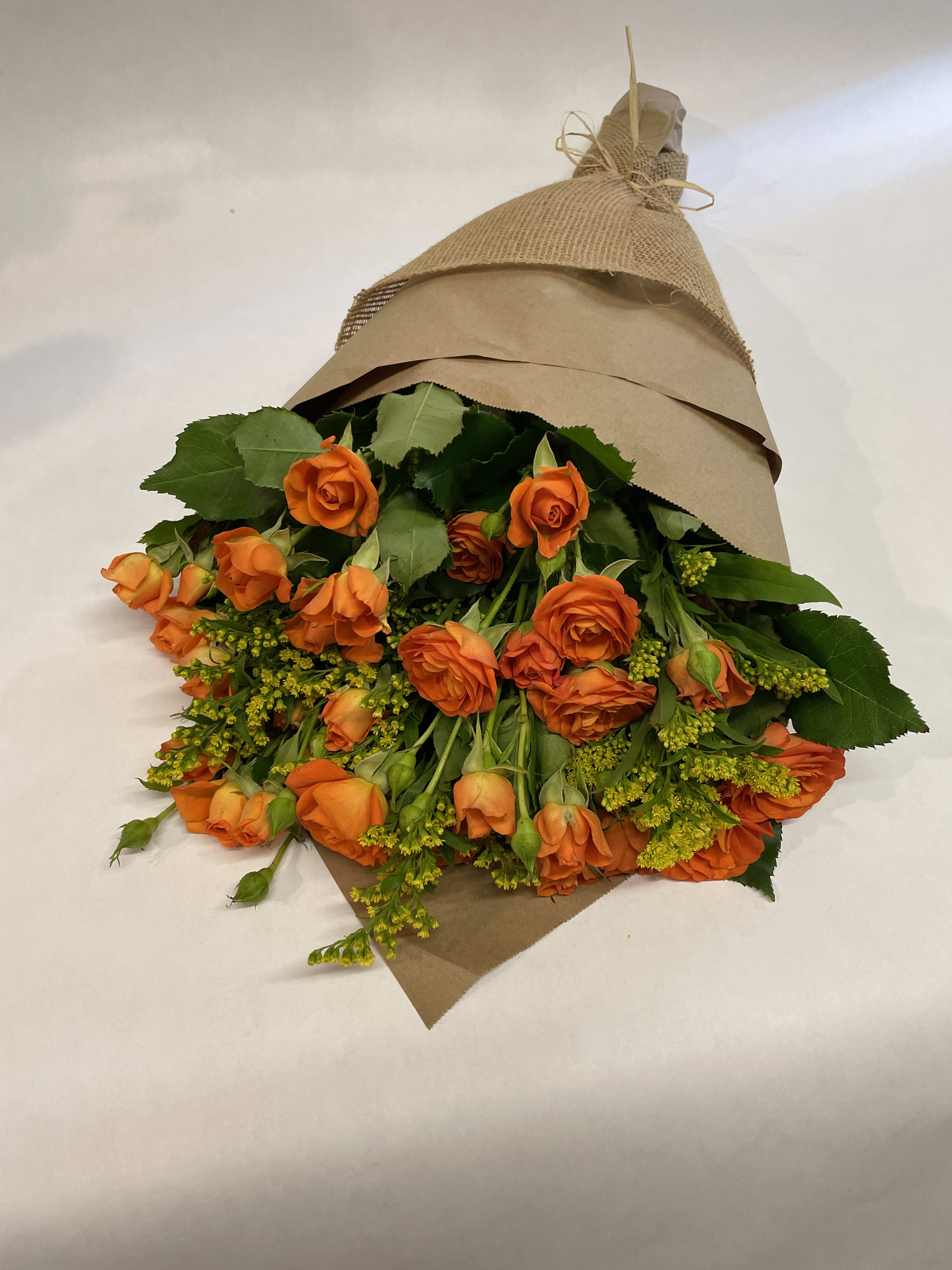Spray Roses Wrap. - This simple and bright autumn bouquet comes wrapped with brown paper, all tied off with a raffia bow. (Some flower colors may be subject to change depending on the season. We will contact you with available flower substitutions; please contact us with specific questions if you are concerned with flower availability, thanks!) Featured arrangement: $65.75 (Regular Price)