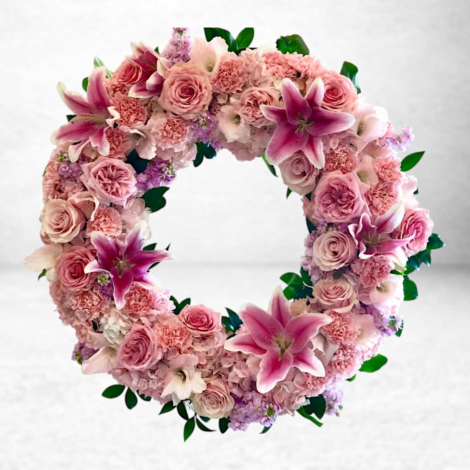 Pink Remembrance Funeral Wreath Pink Remembrance Funeral Wreath - Honor a beautiful life with our Pink Remembrance Wreath, handcrafted with premium pink lilies, roses, carnations, and delicate blooms in shades of blush and mauve. This lush, circular floral tribute symbolizes eternal love and peaceful remembrance, offering comfort and grace during times of loss. Designed exclusively by Twigs and Blooms, your trusted Galveston florist, this sympathy wreath is a stunning choice for funeral services, memorials, or cremation ceremonies throughout the Texas Gulf Coast, including Friendswood, League City, Dickinson, Alvin, and Santa Fe. Whether you're sending condolences to a local funeral home or arranging a heartfelt floral tribute, we provide same-day delivery in Galveston and surrounding areas.