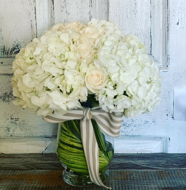 Esperance - Express your deepest condolences and support with our &quot;Esperance&quot;  sympathy arrangement – a delicate mix of white roses and hydrangeas. This thoughtful arrangement serves as a heartfelt gesture, showing how much you care during this difficult time.
