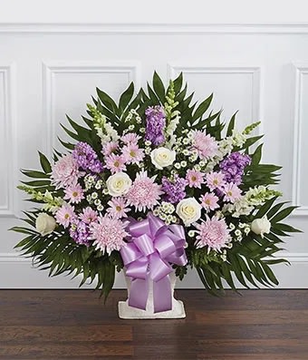 Lavender &amp; White Sympathy Floor Basket - Florist of Omaha - The purple and white flower sympathy floor basket is a wonderful gift to express your care. It is carefully crafted with white and lavender blooms including roses, snapdragons, mums and stock. Floor baskets are typically sent to a family member, friend or co-worker. Medium arrangement (shown) Standard measures approximately  27&quot;H X 30&quot;L. 32&quot;H X 34&quot;L. 34&quot;H X 36&quot;L.  Includes:  • White Roses  • White Snapdragons  • Lavender Stock  • Lavender Mums  • White Monte Casino