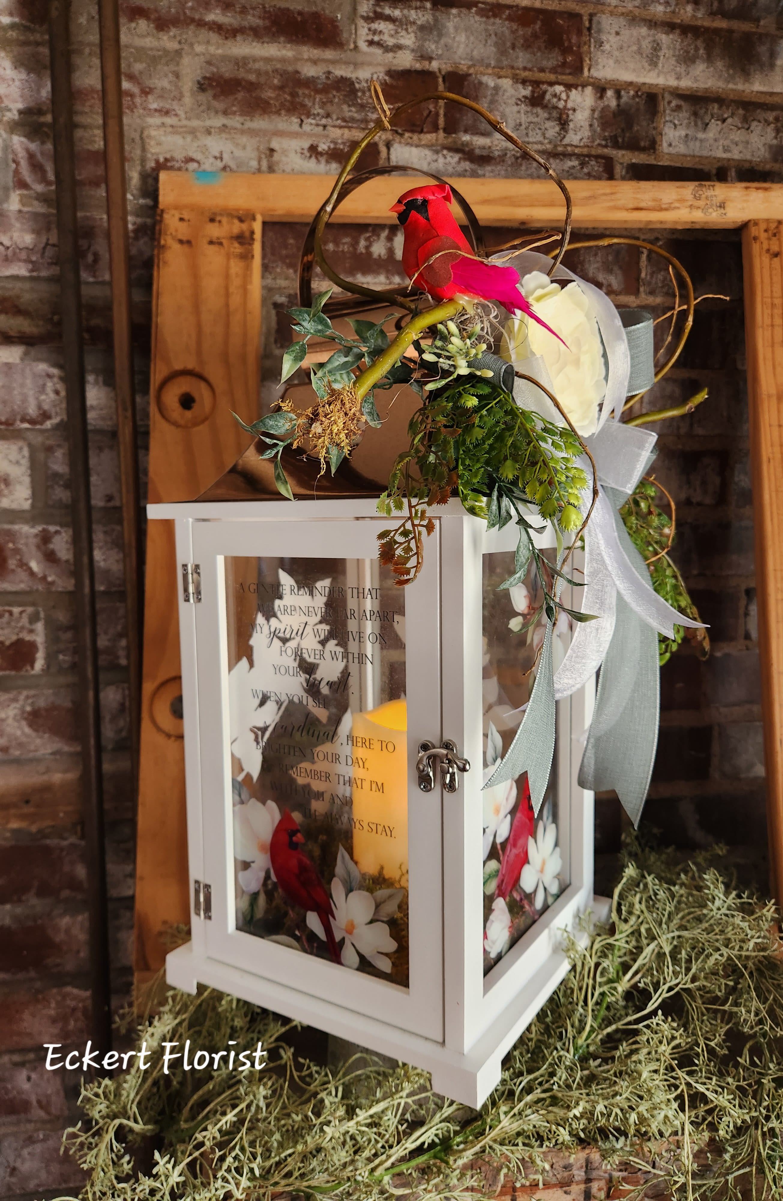 Eckert Florist's &quot;Gentle Reminder&quot; Cardinal Lantern *Our Local Deliverry Only - Our lanterns are made from quality composite wood and a stainless steel copper finish top. They feature a built-in automatic timer which runs for 6 hours on and 18 hours off(3-AAA batteries are included) and are inscribed with sentimental quotes. &quot;A gentle reminder that we are never far apart, my spirit will live on forever within your heart. When you see a cardinal, here to brighten your day, remember that I'm with you and I'll always stay.&quot; W: 9&quot; H: 18.5&quot; D: 9&quot; - Our local delivery only